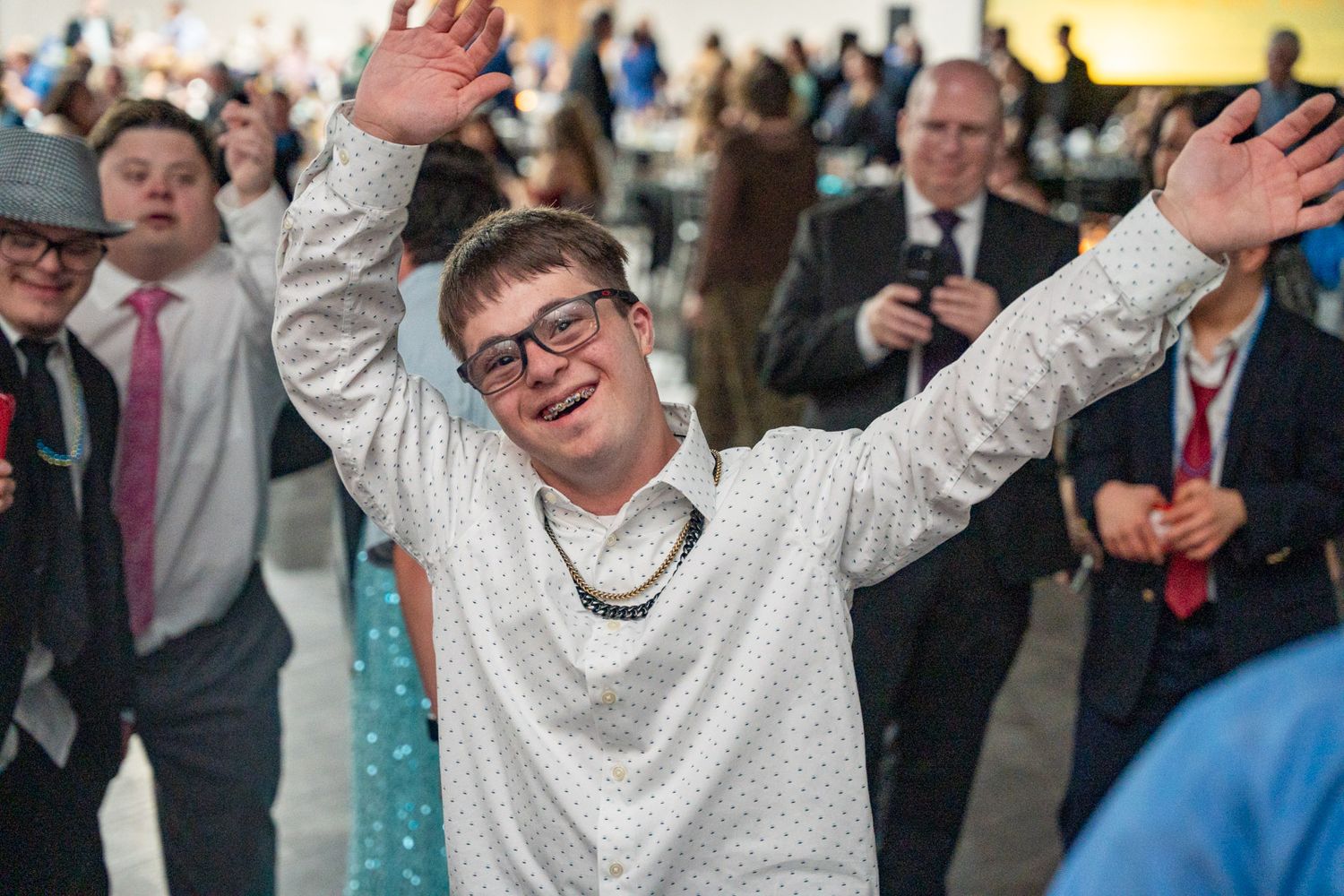 Gigi's Playhouse 2025 Gala event photo boy waving his hands like he just don't care