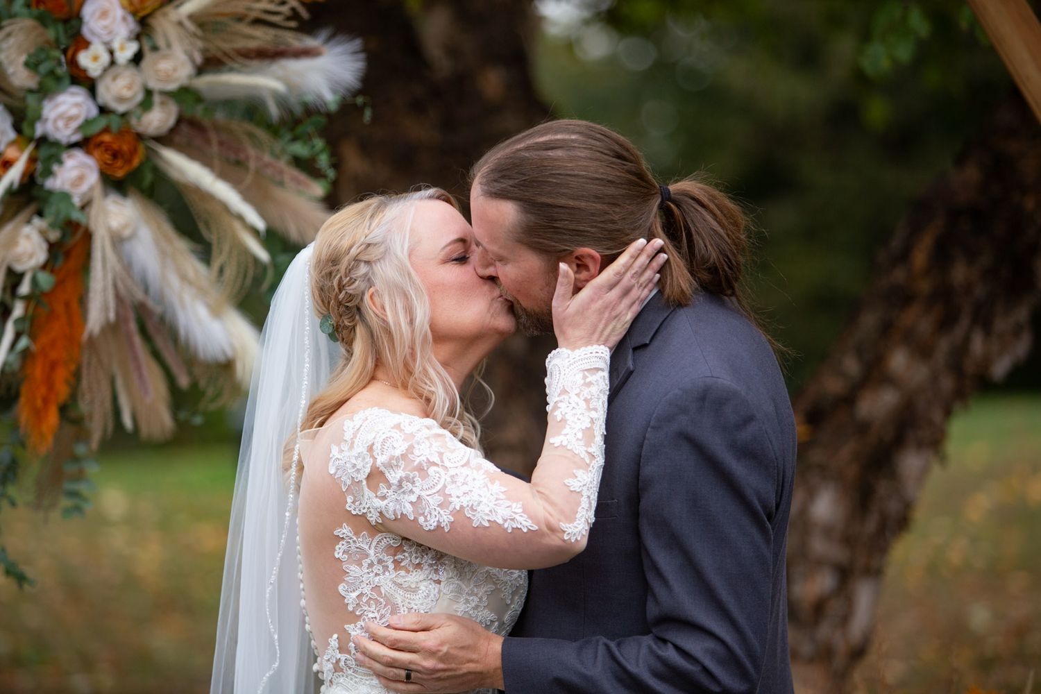 bride and groom kiss during ceremony