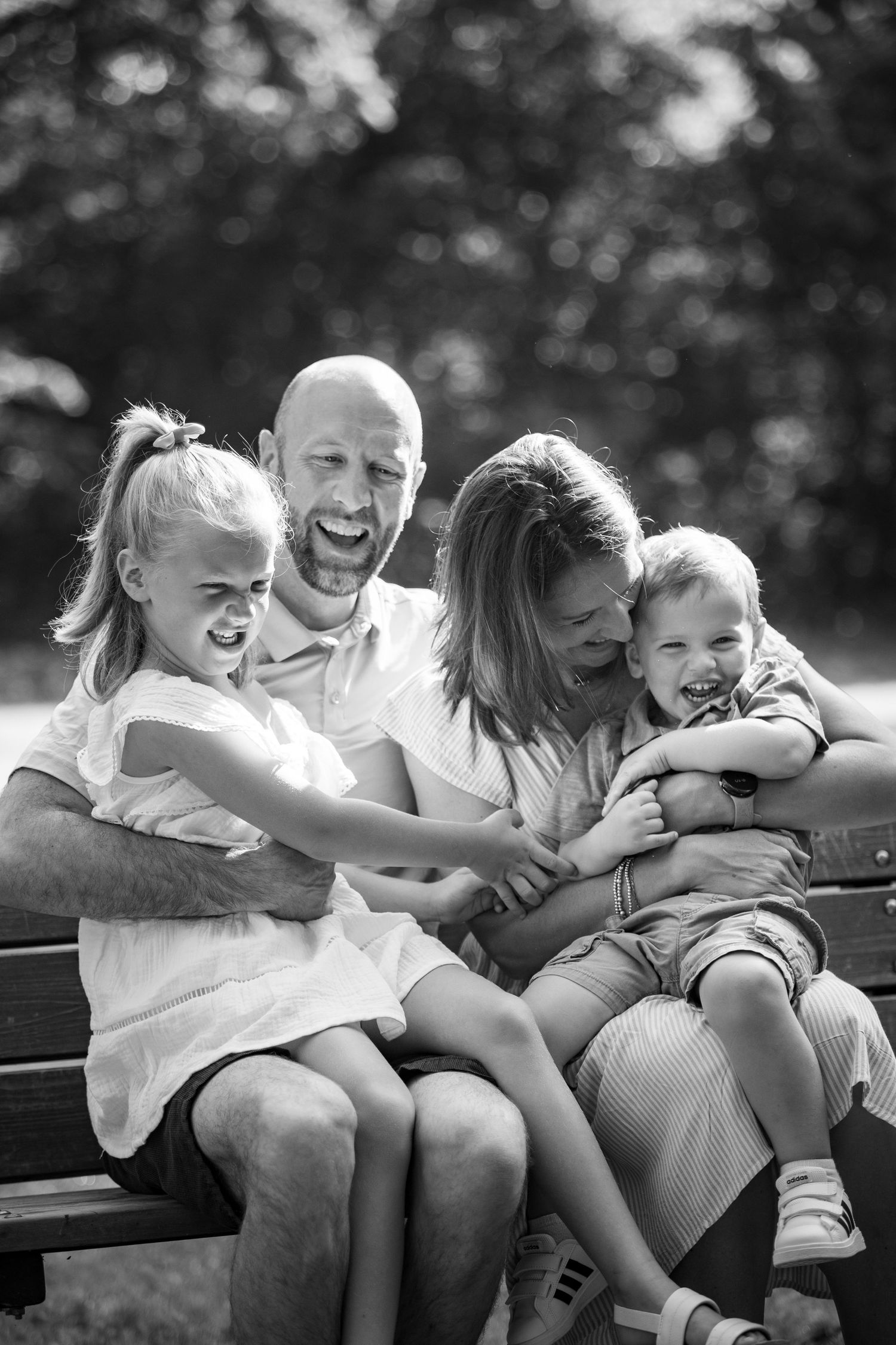 A candid series showing playful interactions between parents and children creating joyful family moments on a bench outdoors.