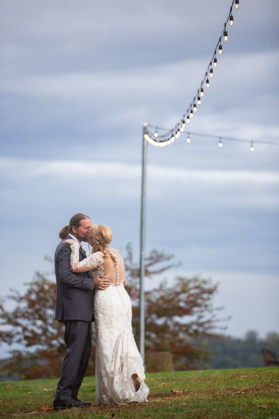 wedding couple kissing under market lights