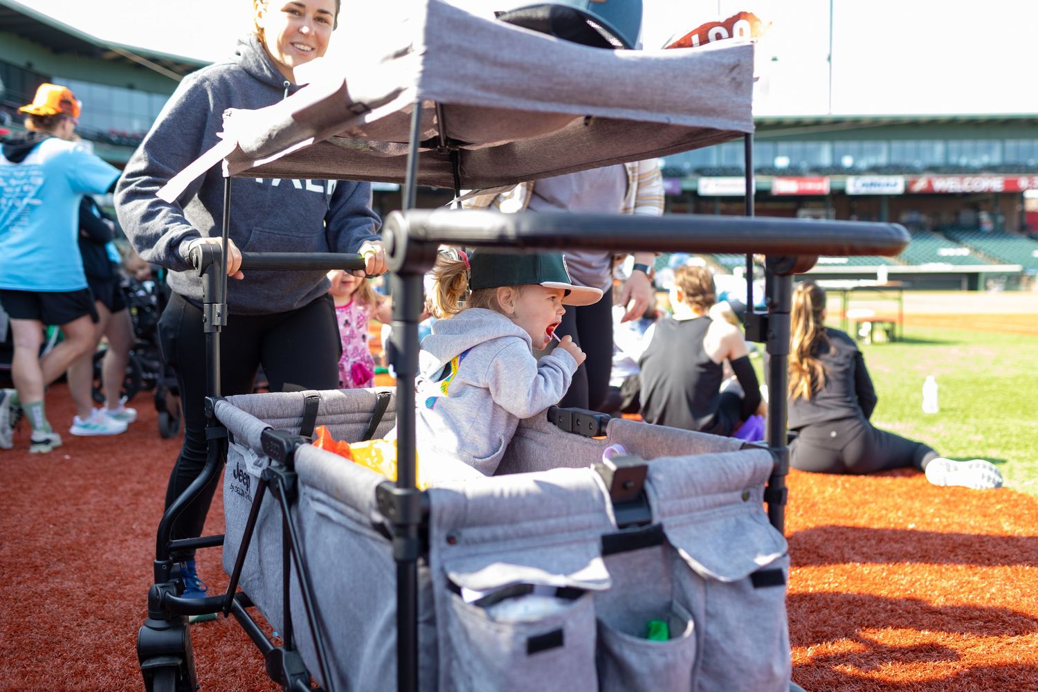 Event staff manage a registration table with equipment at a baseball stadium.