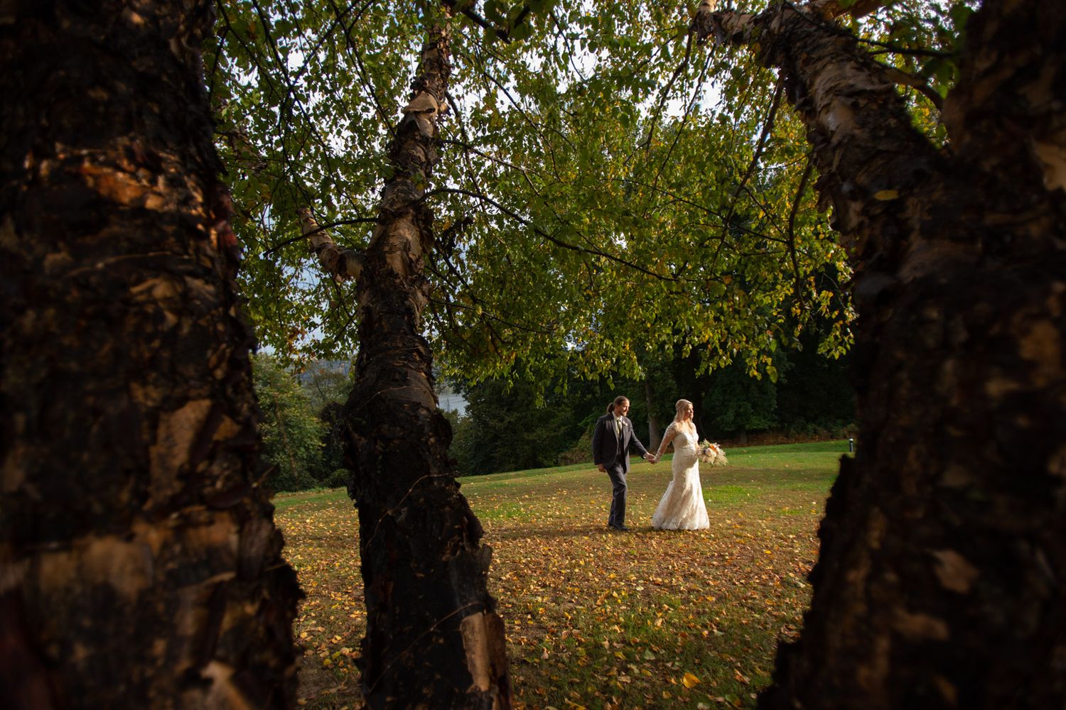 married couple walking through leaves