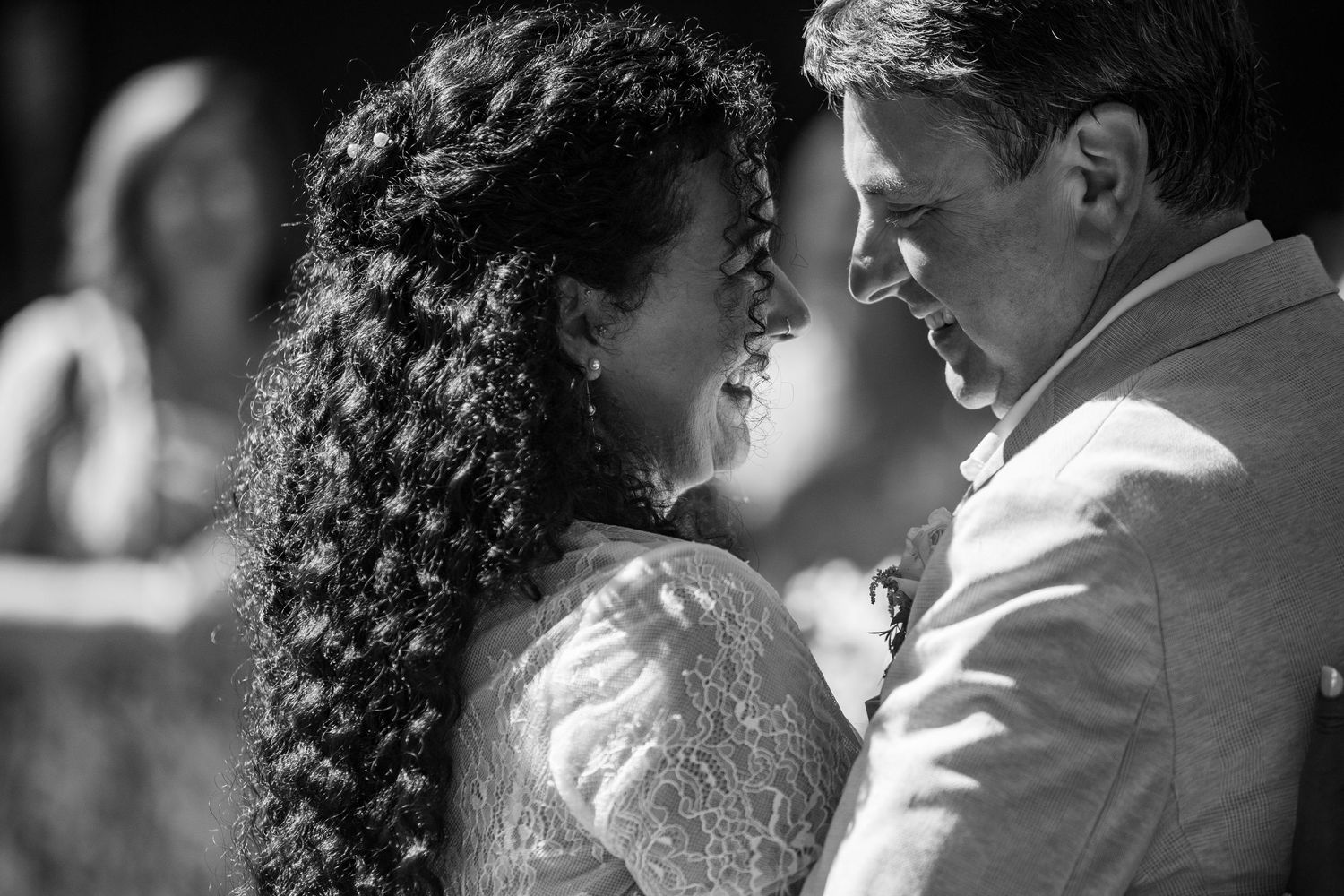 A romantic black and white portrait showing an intimate moment between newlyweds.