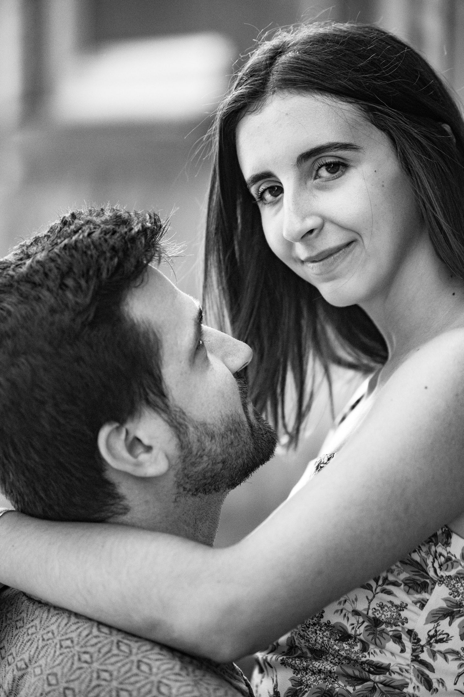 A romantic black and white portrait of a couple sharing an intimate moment together.