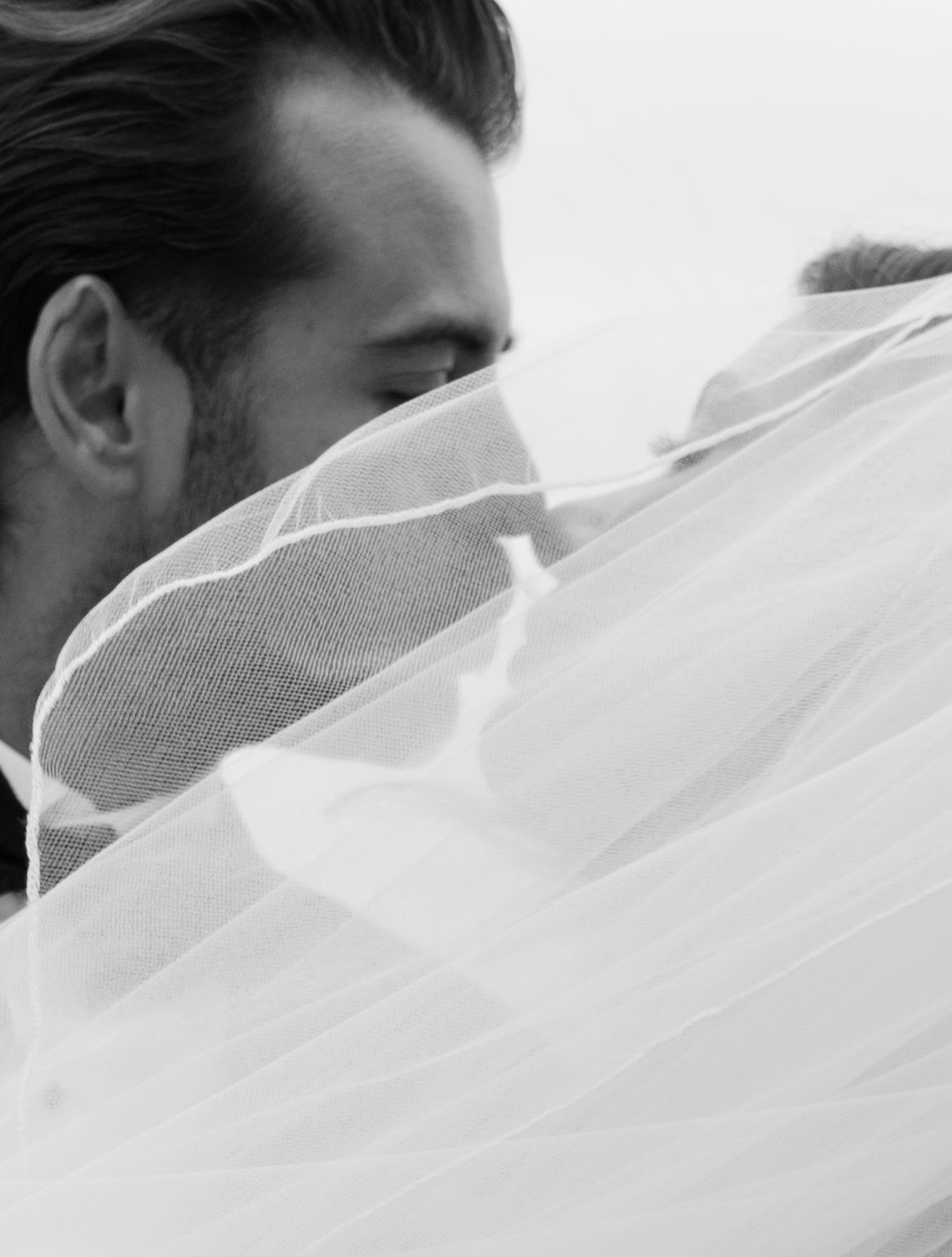 Intimate black and white close-up of white wedding veil fabric.