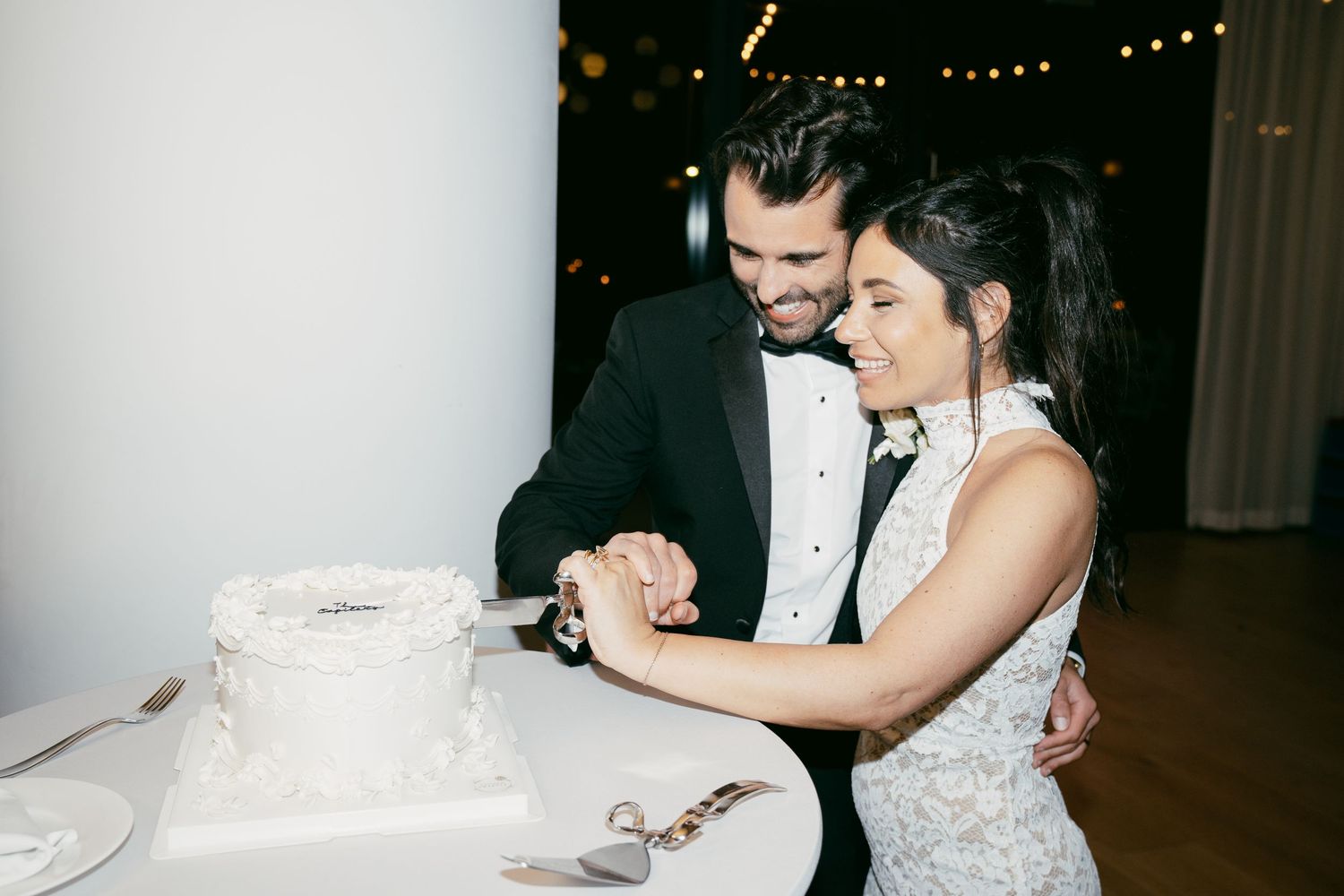 Artistic low-light candid reception moments at an indoor wedding celebration.