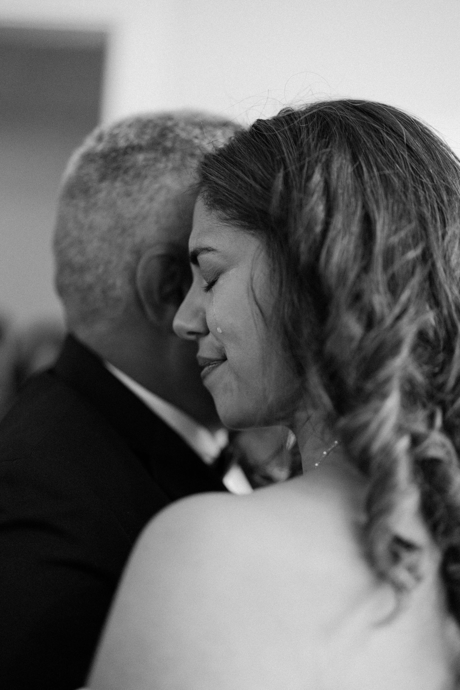An intimate black and white portrait showcasing tender emotions between loved ones.