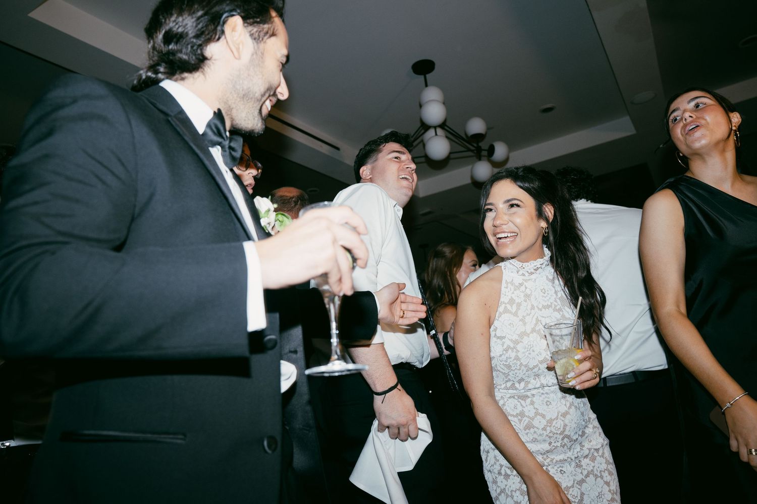 Wedding guests dance and celebrate together during a lively reception party.