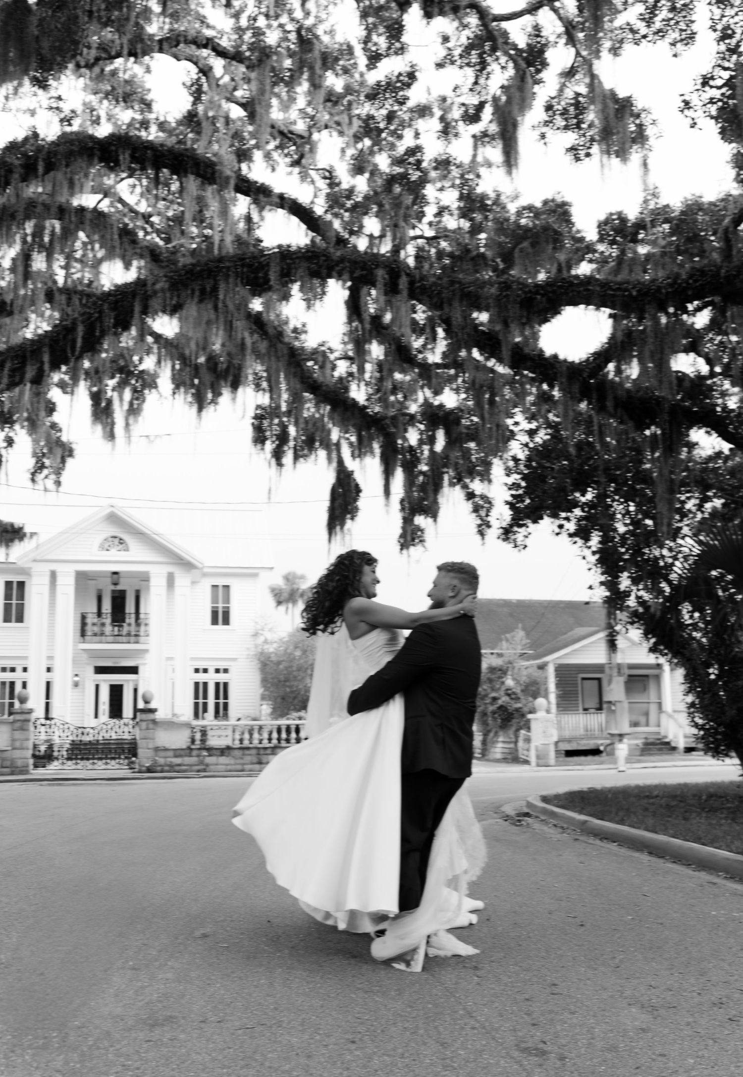A romantic bridal photo sequence under Spanish moss draped trees in front of a white Southern mansion.