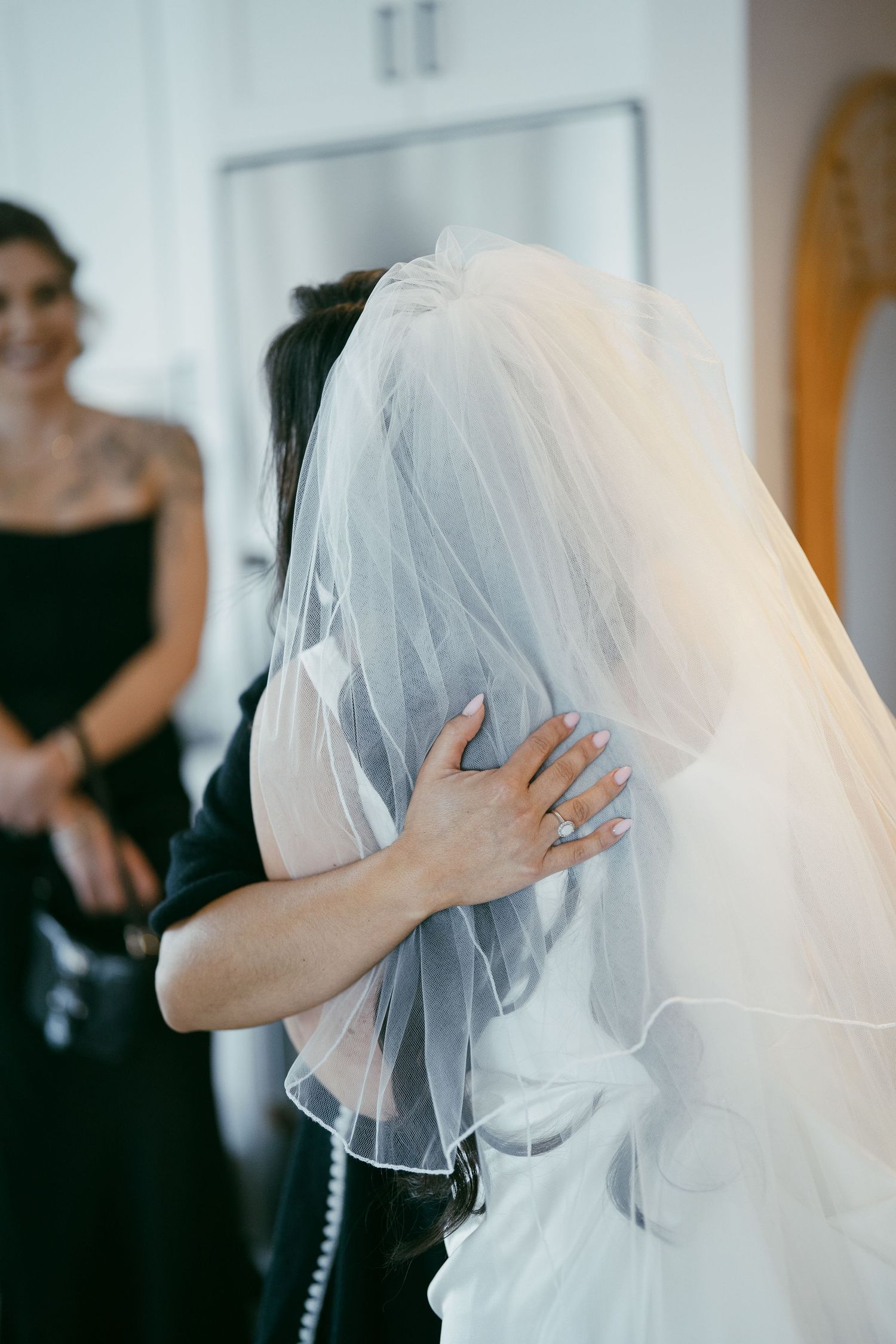 A series of photos showing a delicate white bridal veil being adjusted and styled during wedding preparations.