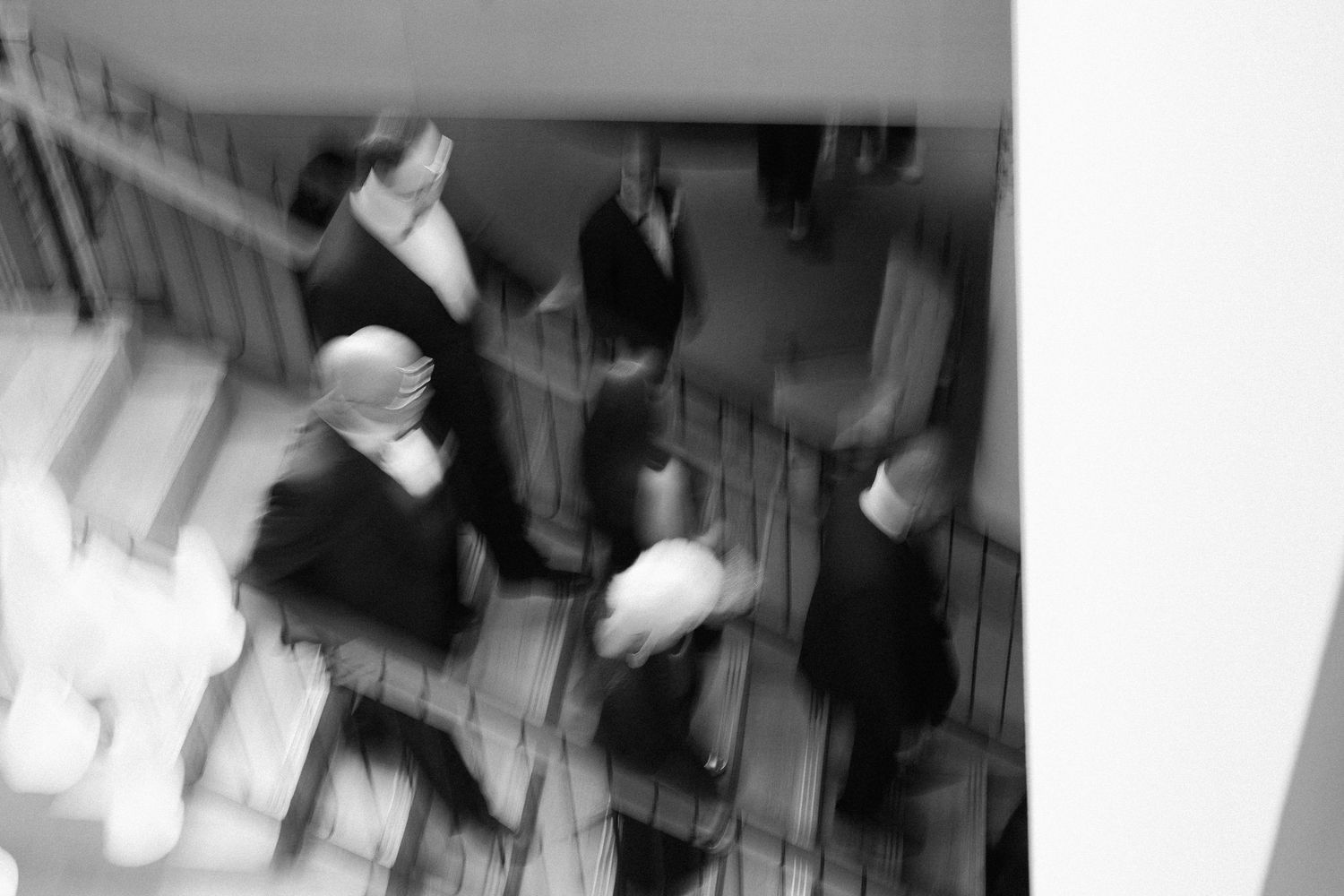Abstract motion blur black and white photographs showing movement in an interior space.
