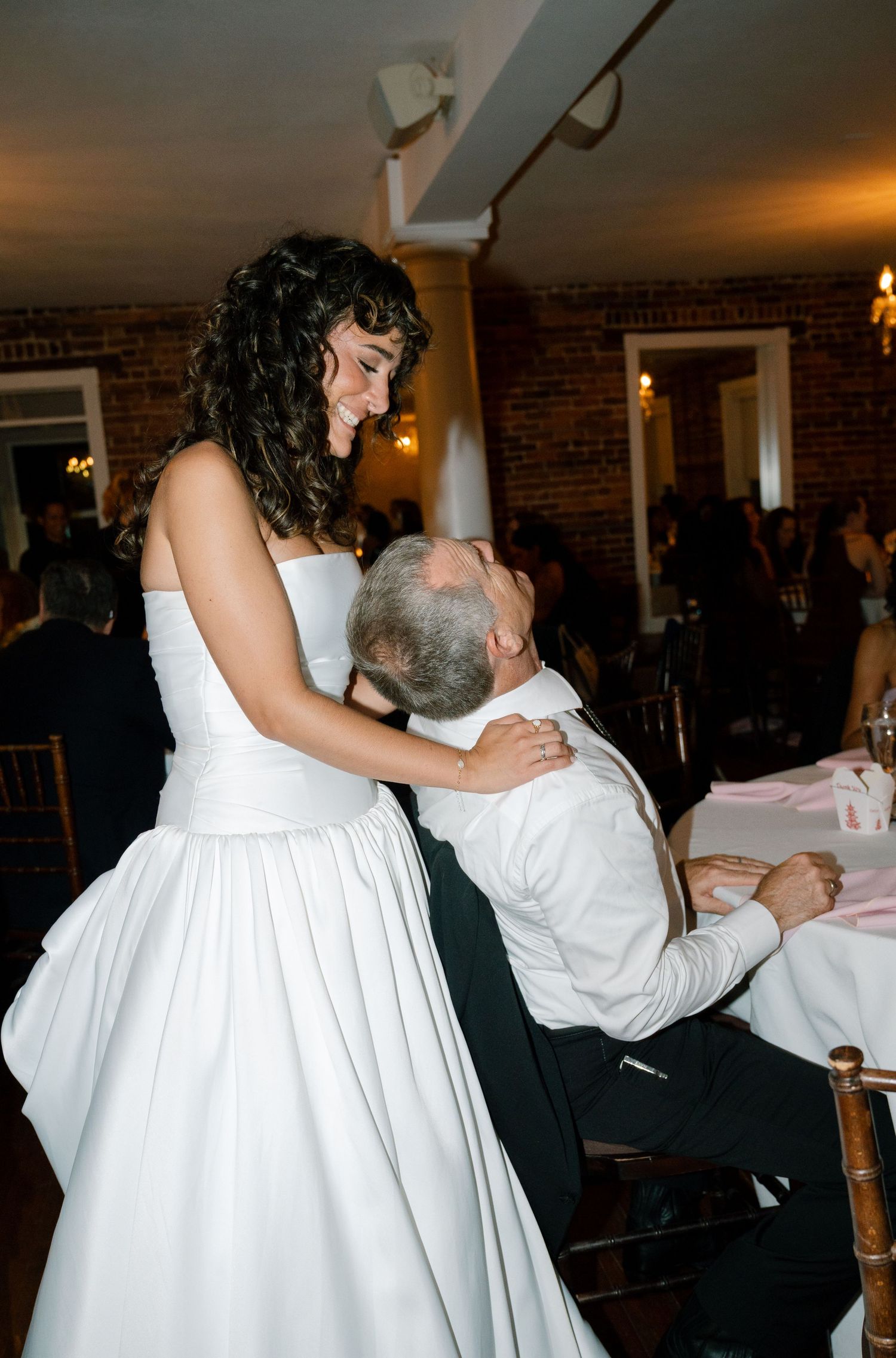 A tender moment shared during a wedding reception dance.