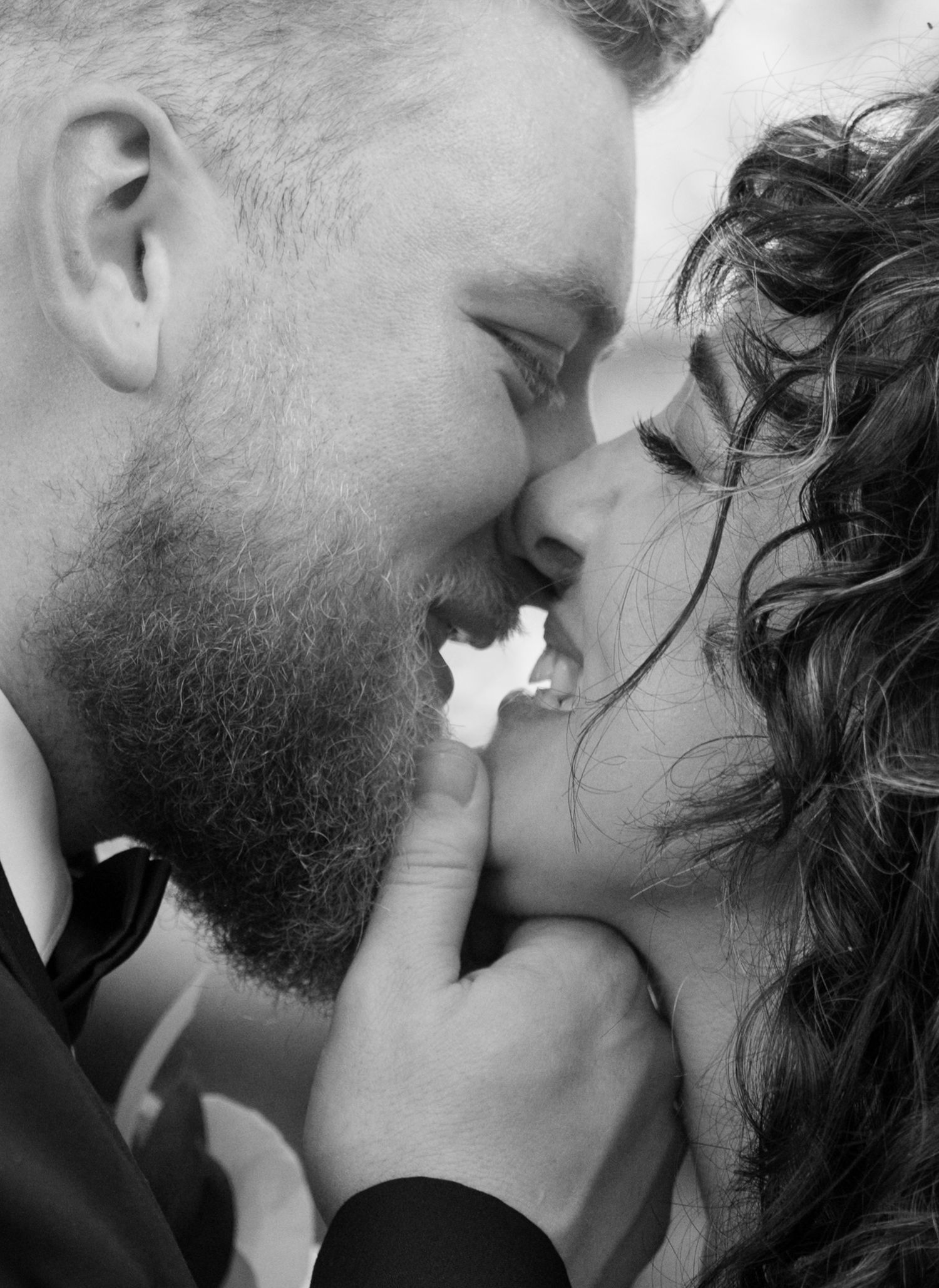 Intimate black and white close-up of romantic moment between newlyweds.