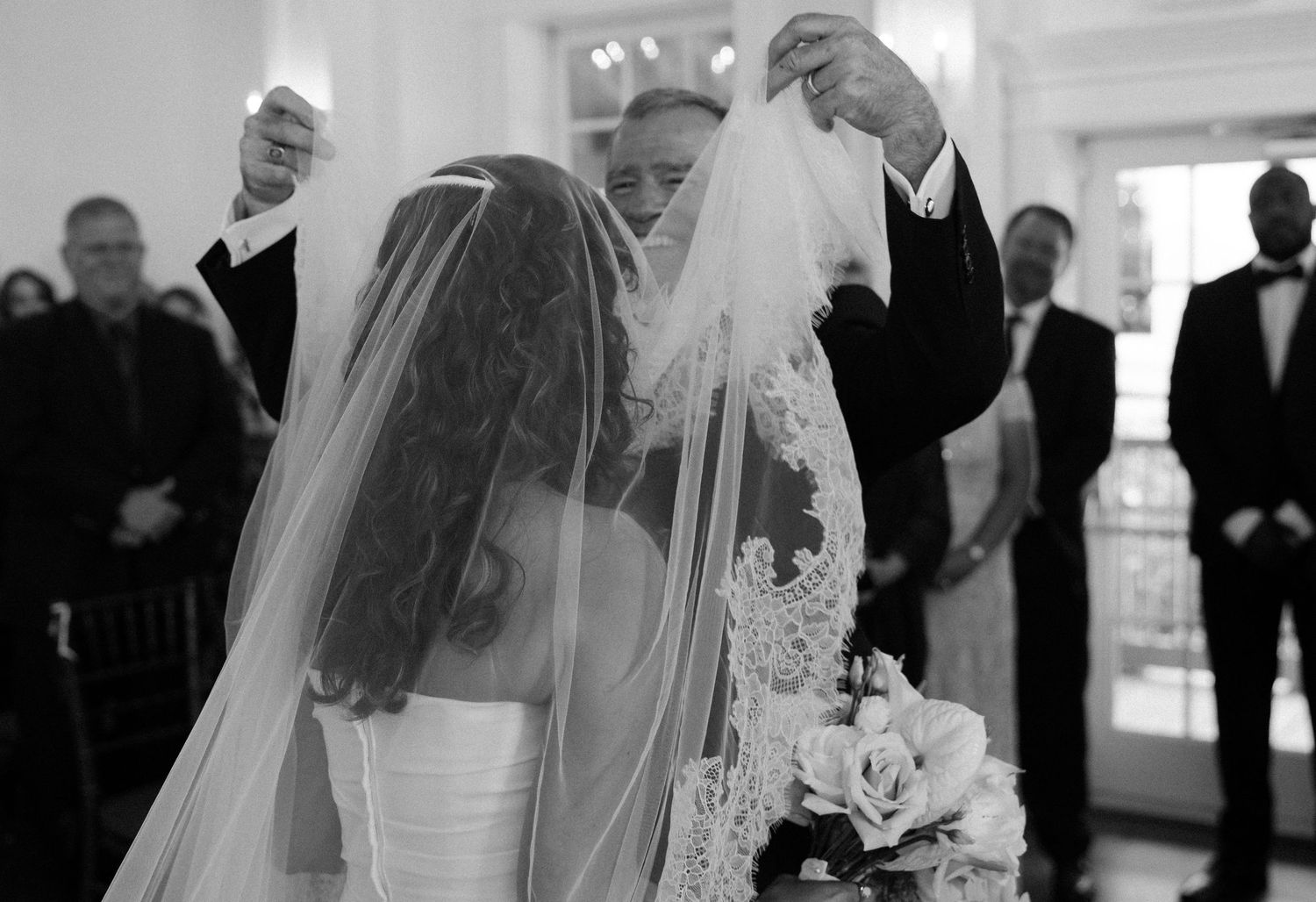 Black and white photos capturing emotional moments during a wedding ceremony.