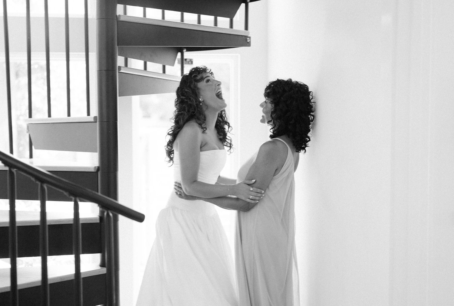Minimalist black and white wedding preparation photos in white room with natural light.