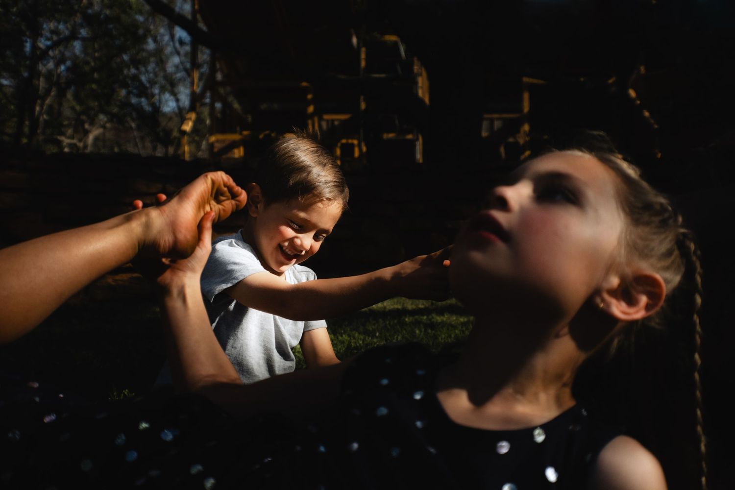 Brother teasing sister, while sister holding other sisters foot, captured during family shoot at Intiem Weddings by Wouter Kleynhans