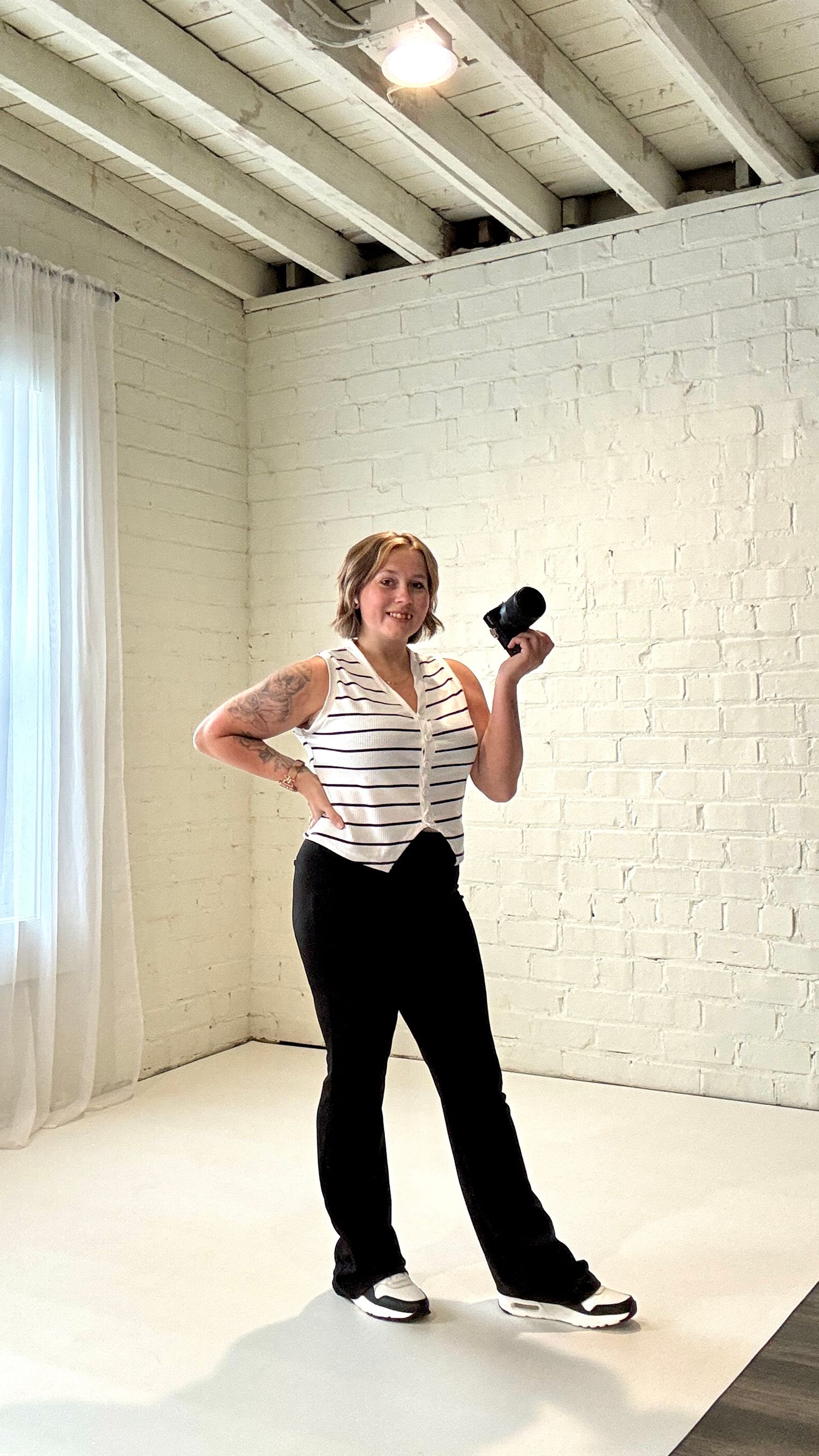 A sequence of playful dance moves against a white brick wall in a bright studio space.