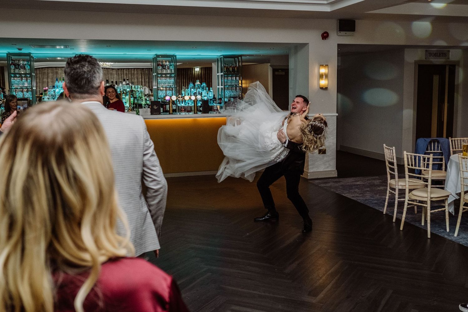 Bride and groom surrounded by guests