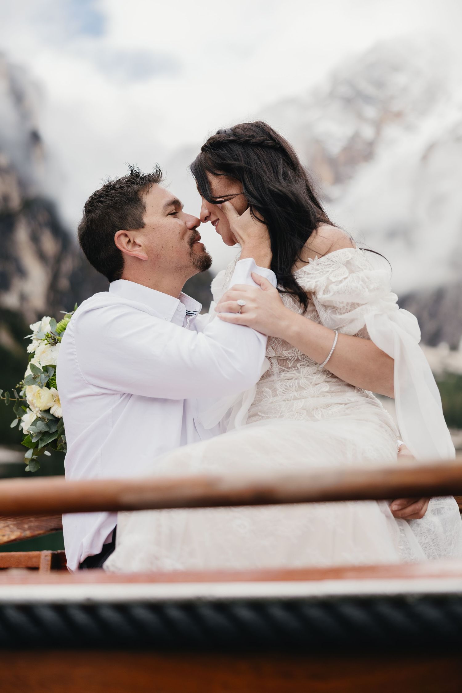 A romantic series of wedding photos showing a couple in loving embrace against a snowy mountain backdrop.