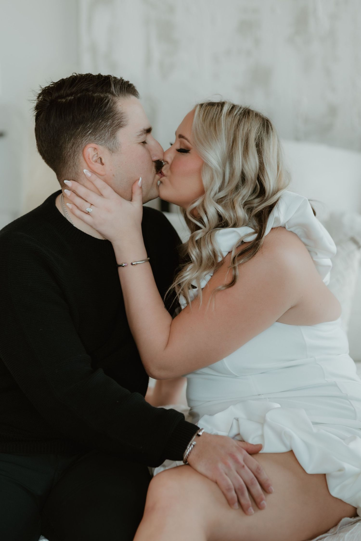 A romantic black and white photoshoot sequence showing tender intimate moments between a couple in formal attire.