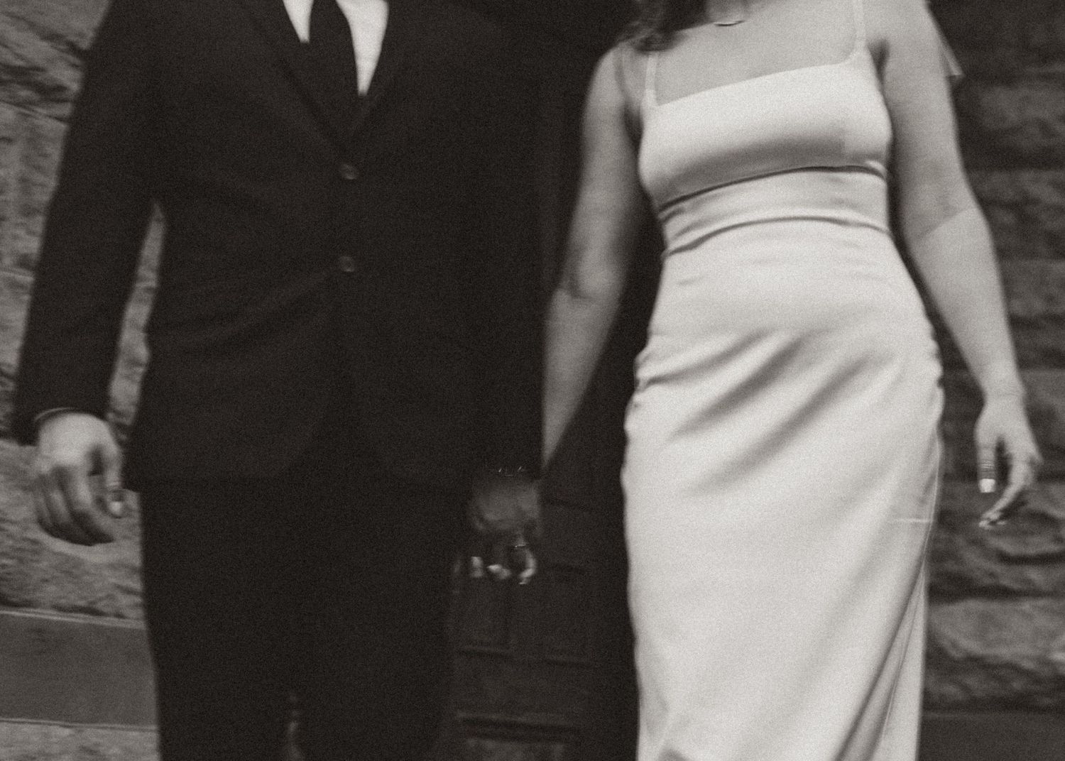 Black and white close-up photo of a couple in wedding attire showing their formal sophistication.