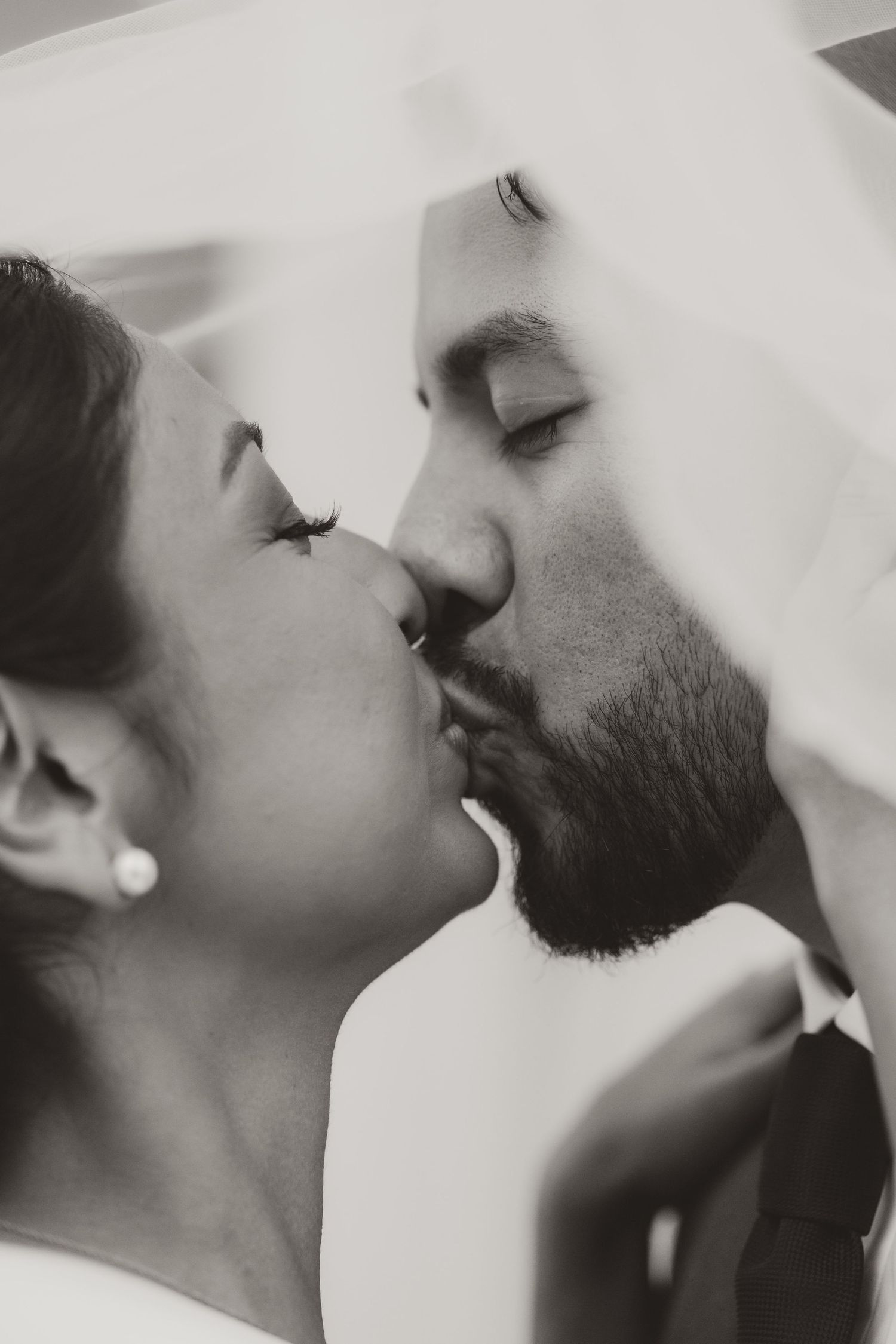 Black and white artistic photographs show couples sharing intimate romantic kisses in a minimalist stylized composition.