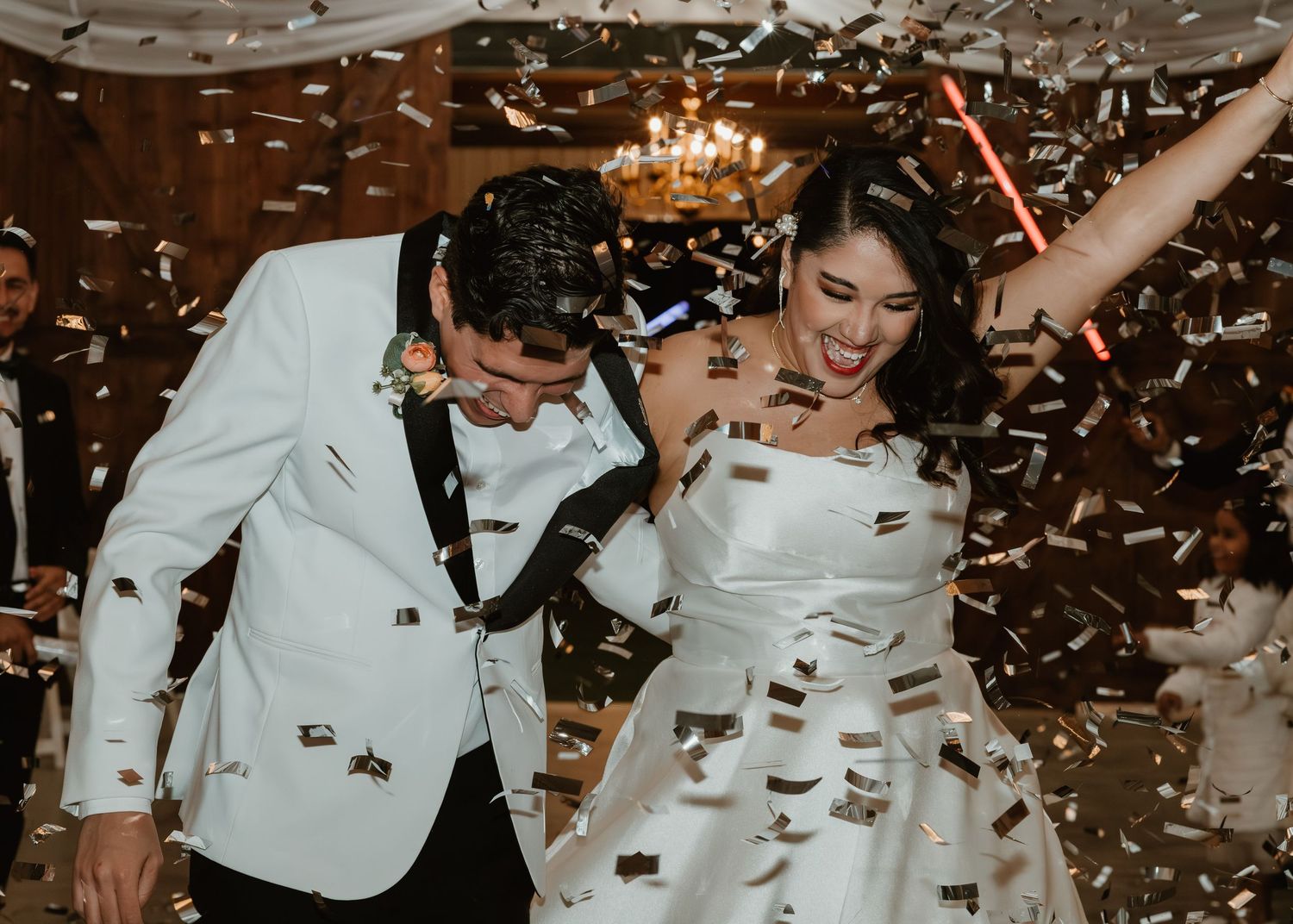 Sequence of wedding celebrations showing falling confetti and joyful dance movements in elegant indoor venue.