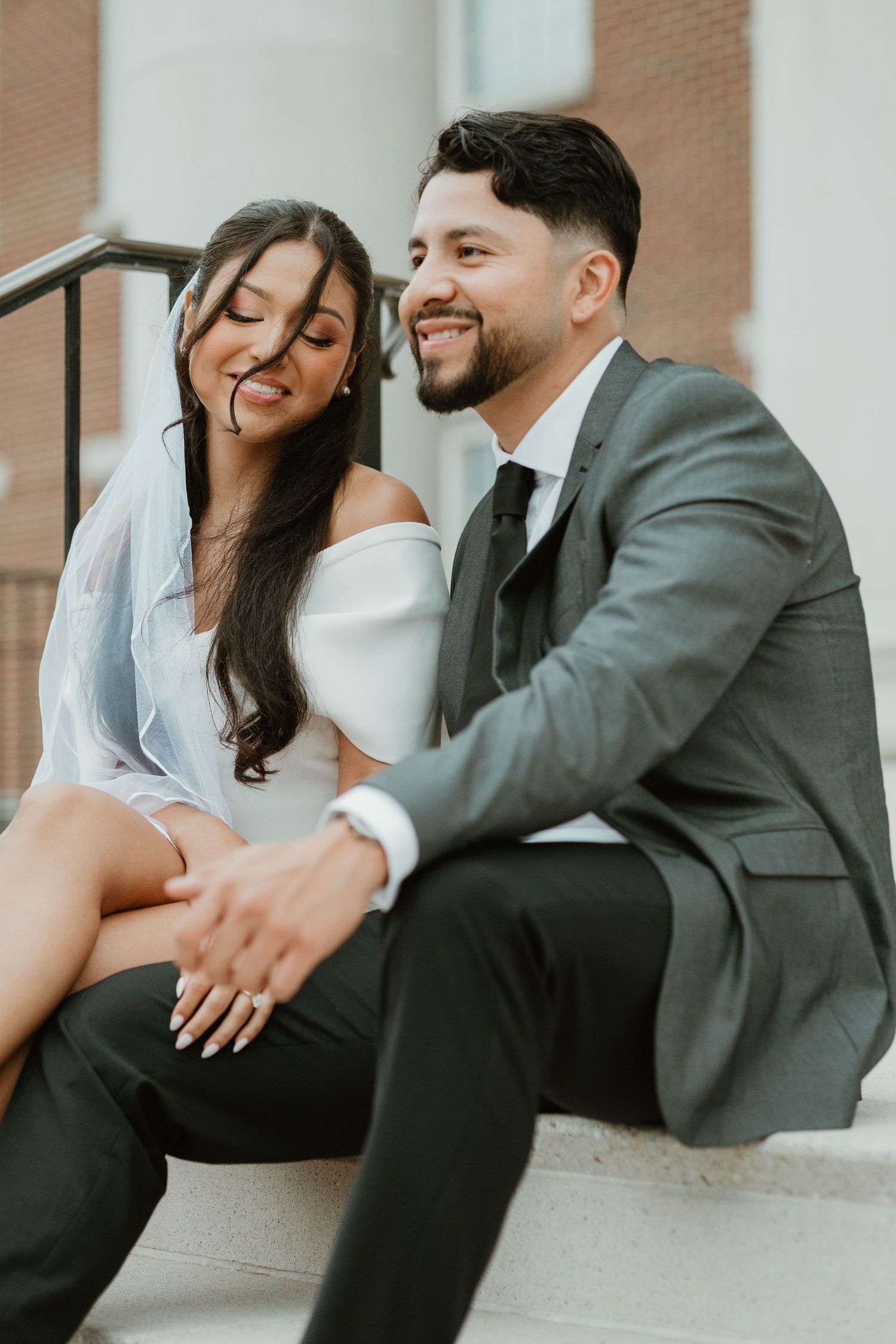 Intimate wedding portrait series showing candid moments between newlyweds against a brick wall background.