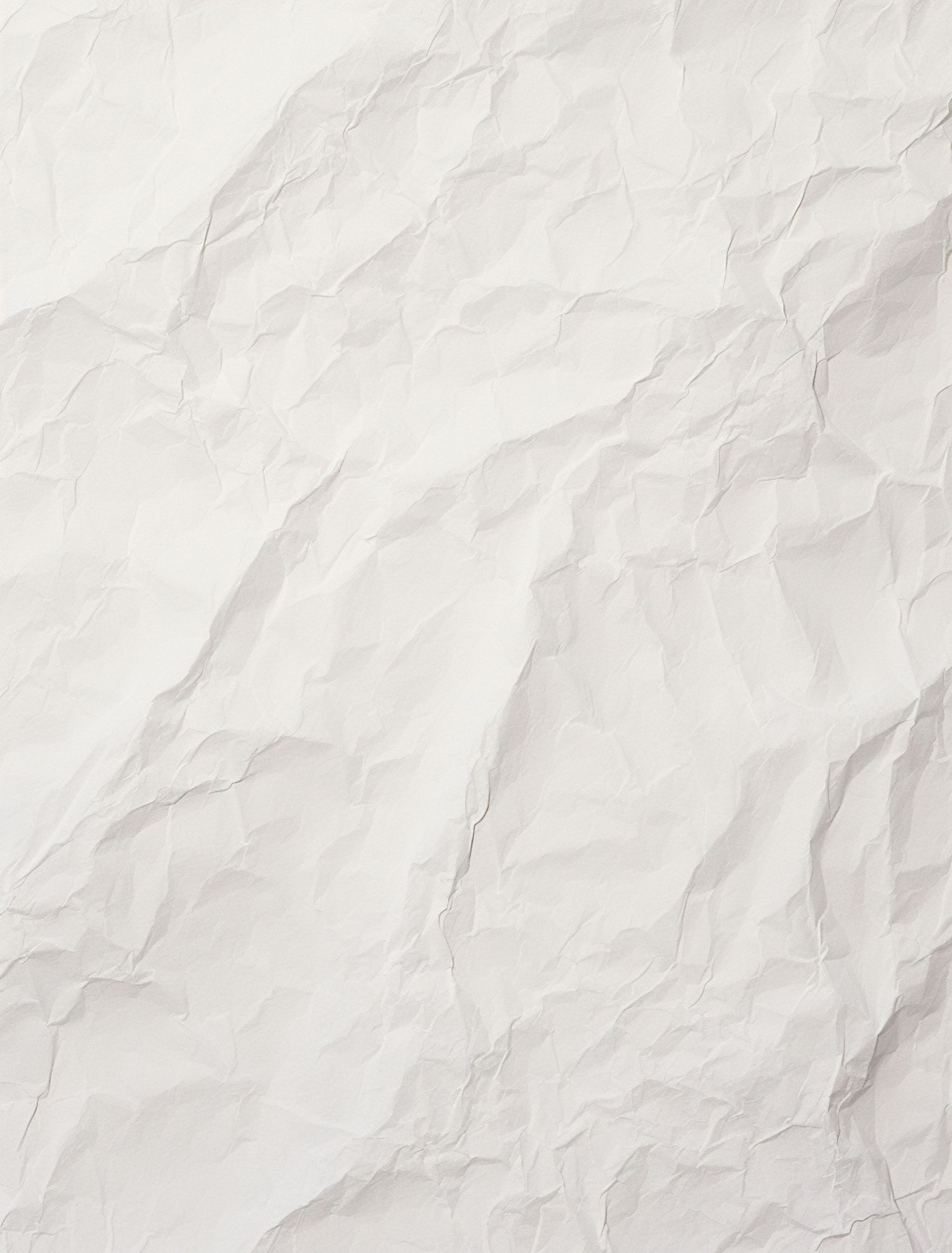 Crumpled white paper texture with soft shadows and wrinkles.