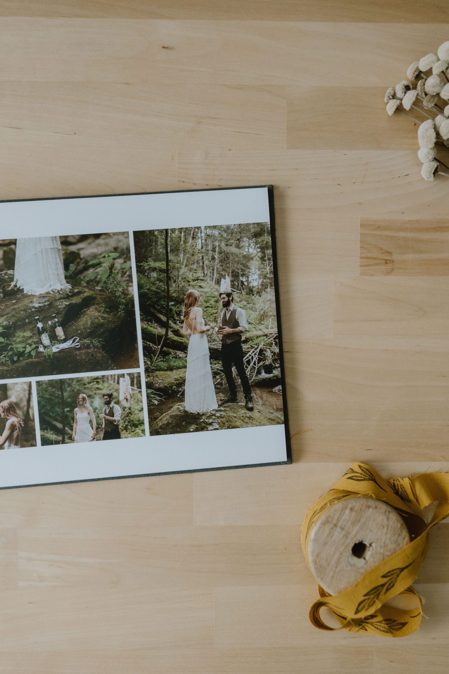 Wedding photo album spread showing outdoor forest ceremony images with yellow ribbon accent.