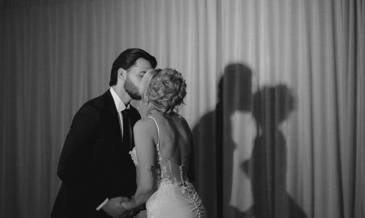 Romantic black and white dance floor moment captured at an elegant wedding reception.