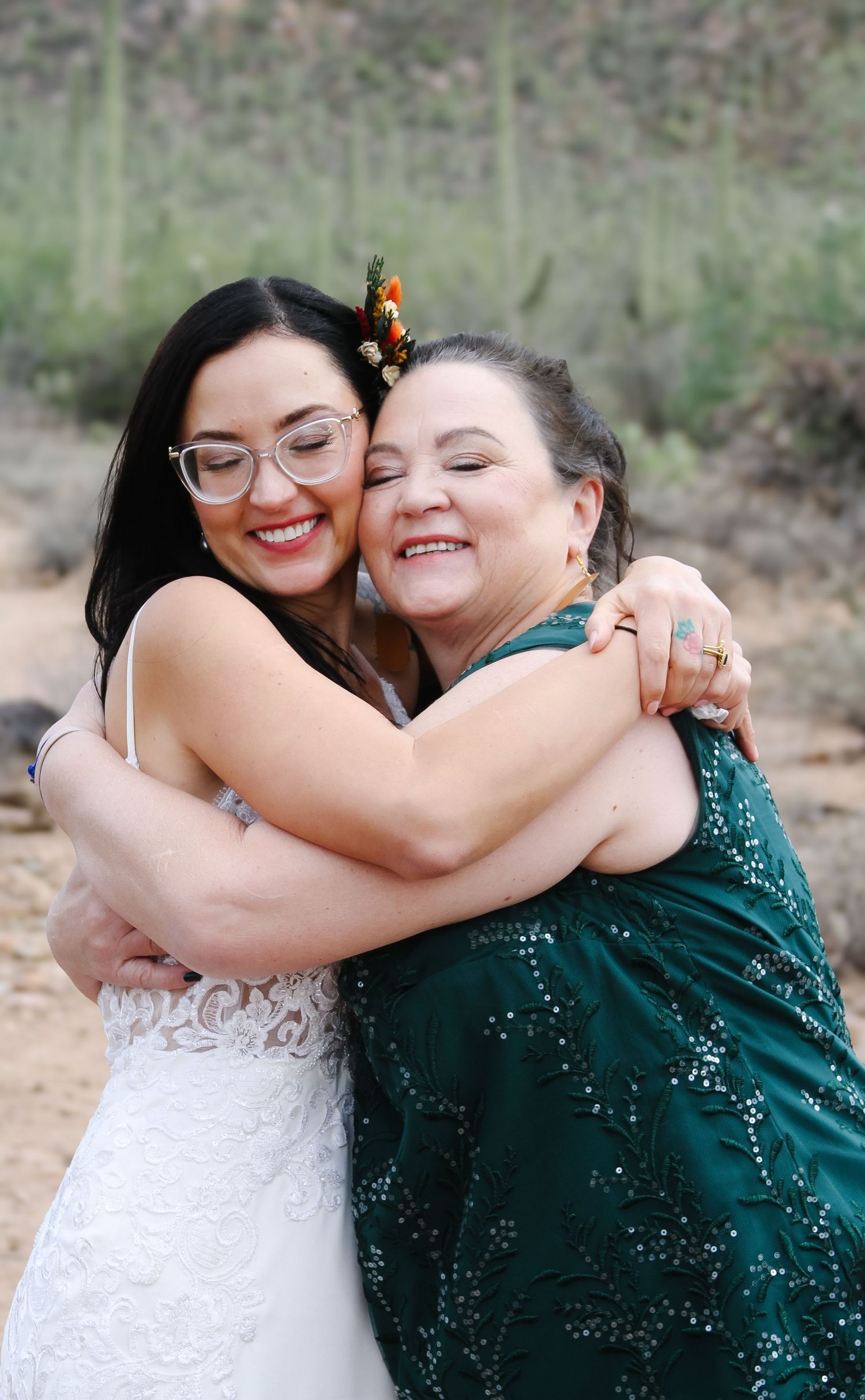 Emotional wedding moments showing joyful embraces in the desert setting.
