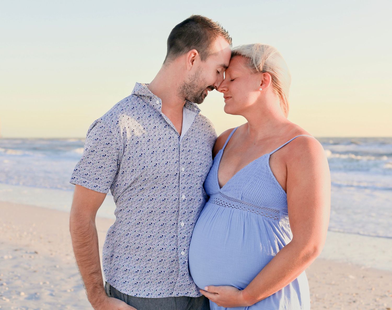 A candid moment from a maternity session done on Marco Island at sunset