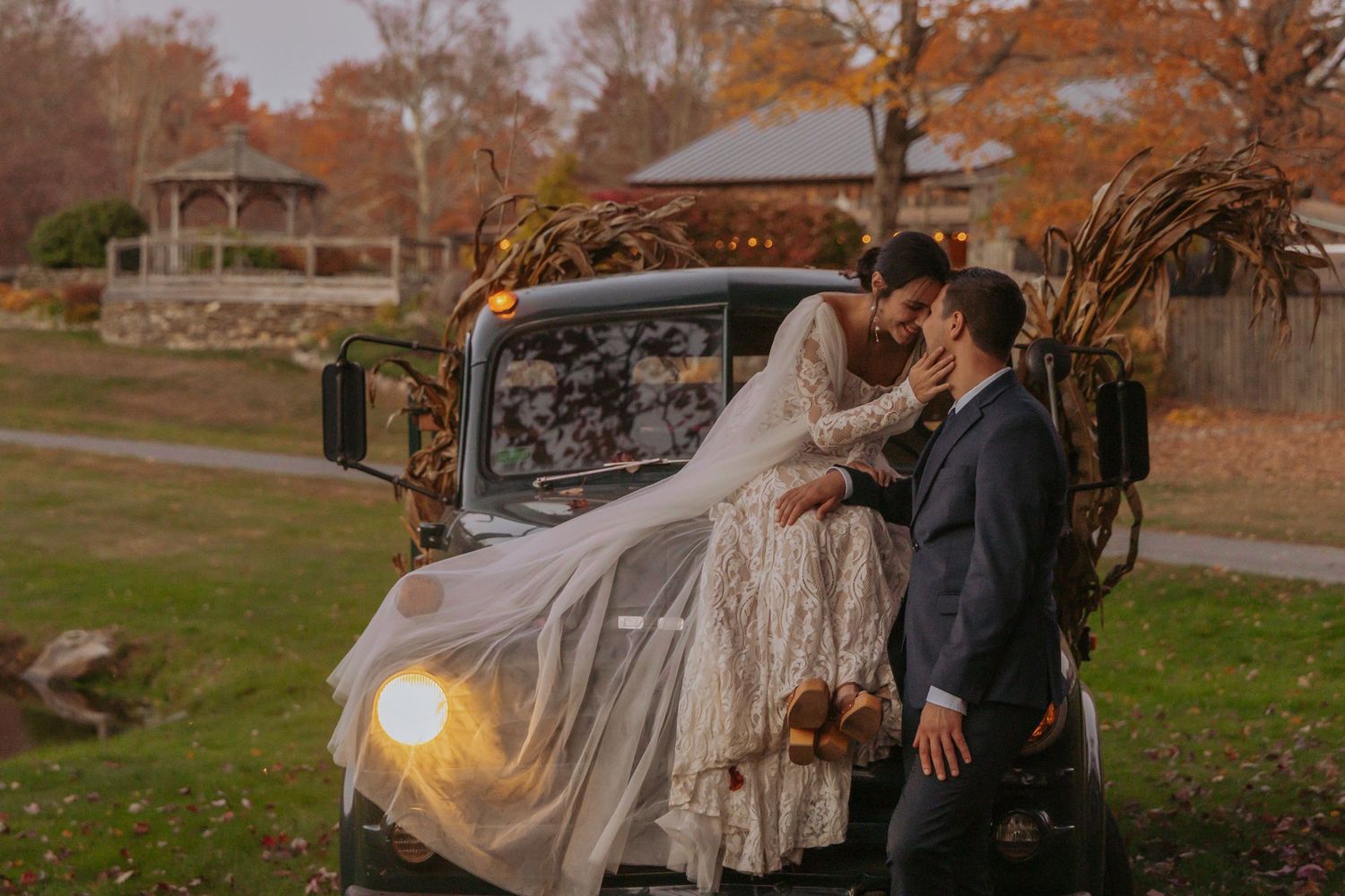 Romantic autumn wedding photos with golden hour lighting and vintage car.