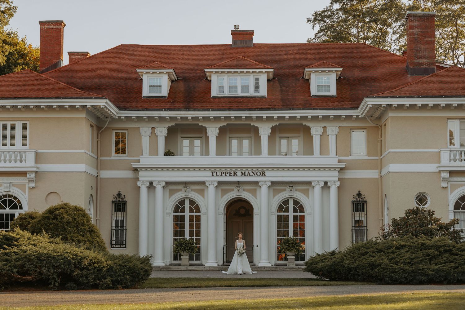 Elegant white mansion wedding venue with classic colonial architecture.