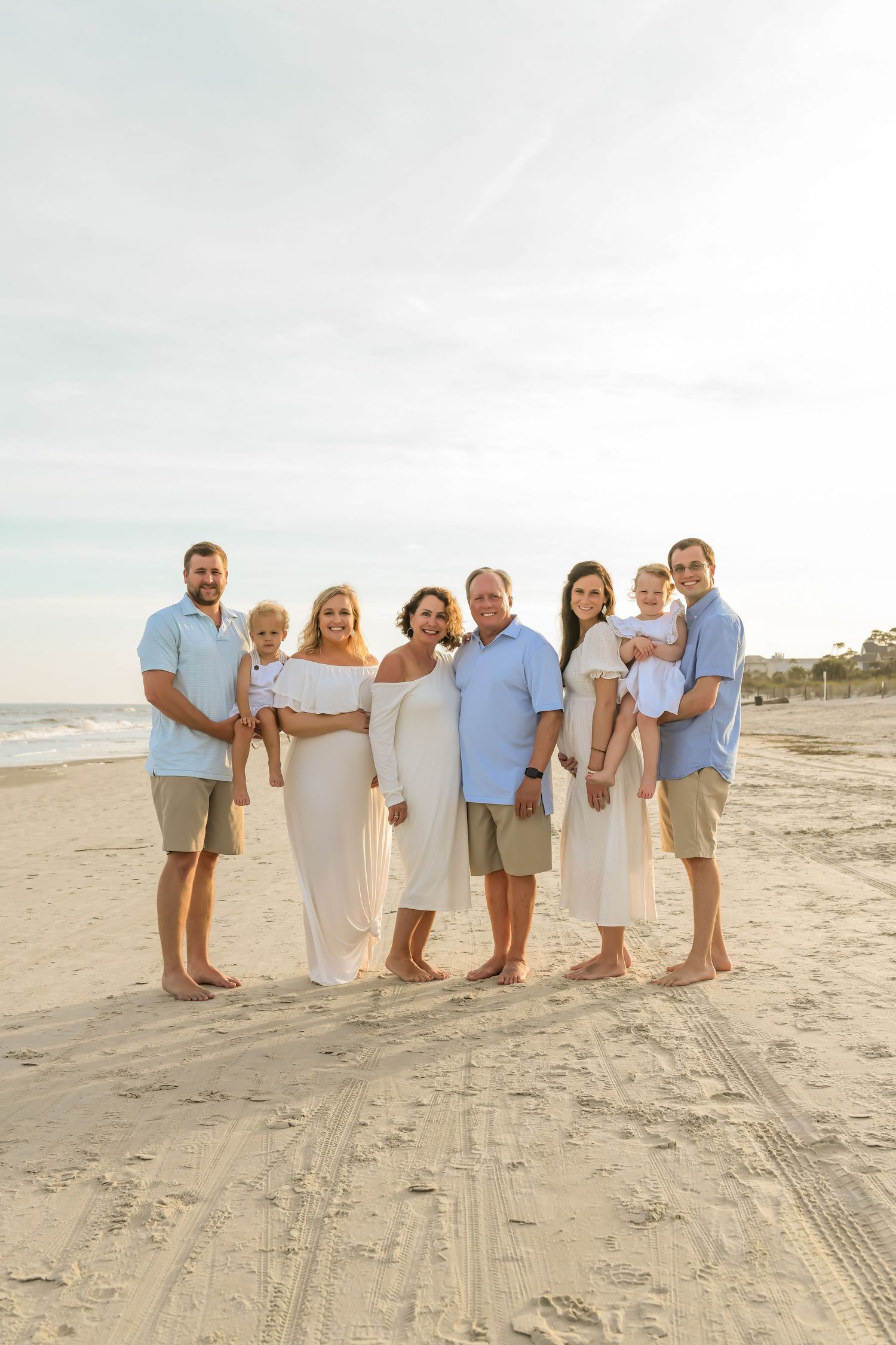 A happy family poses together for a portrait on the beach at sunset on Hilton Head Island.
