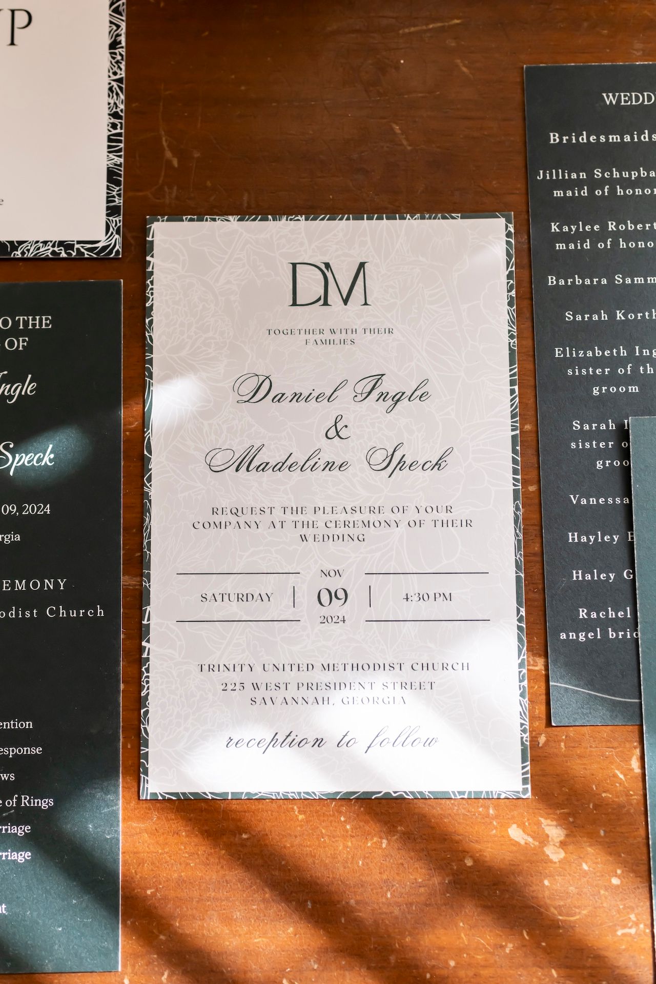 Wedding invitations and stationery samples displayed in navy blue and white colors with modern calligraphy text.