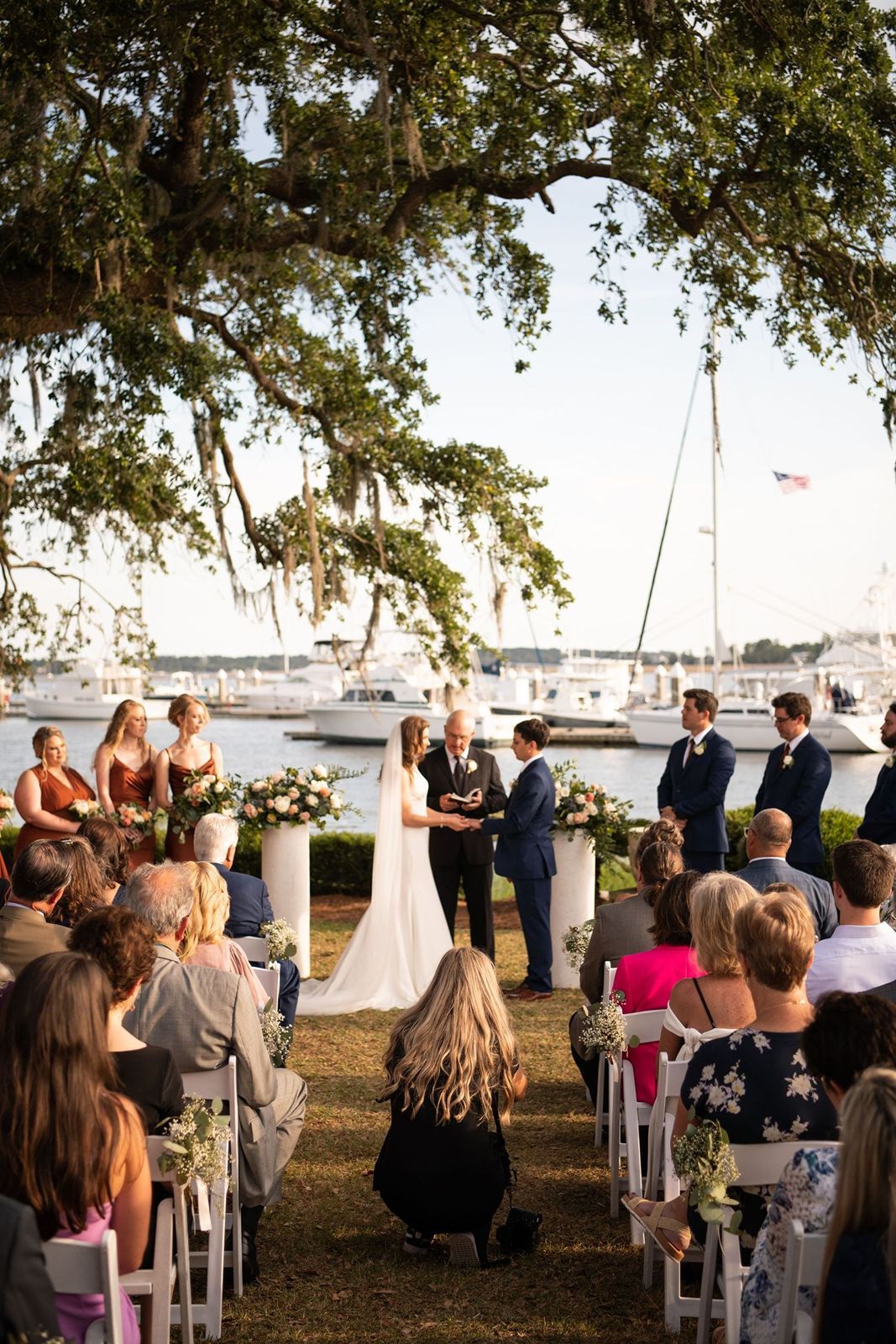 Candid shot of a top photographer in Savannah, GA, capturing a wedding ceremony in action.