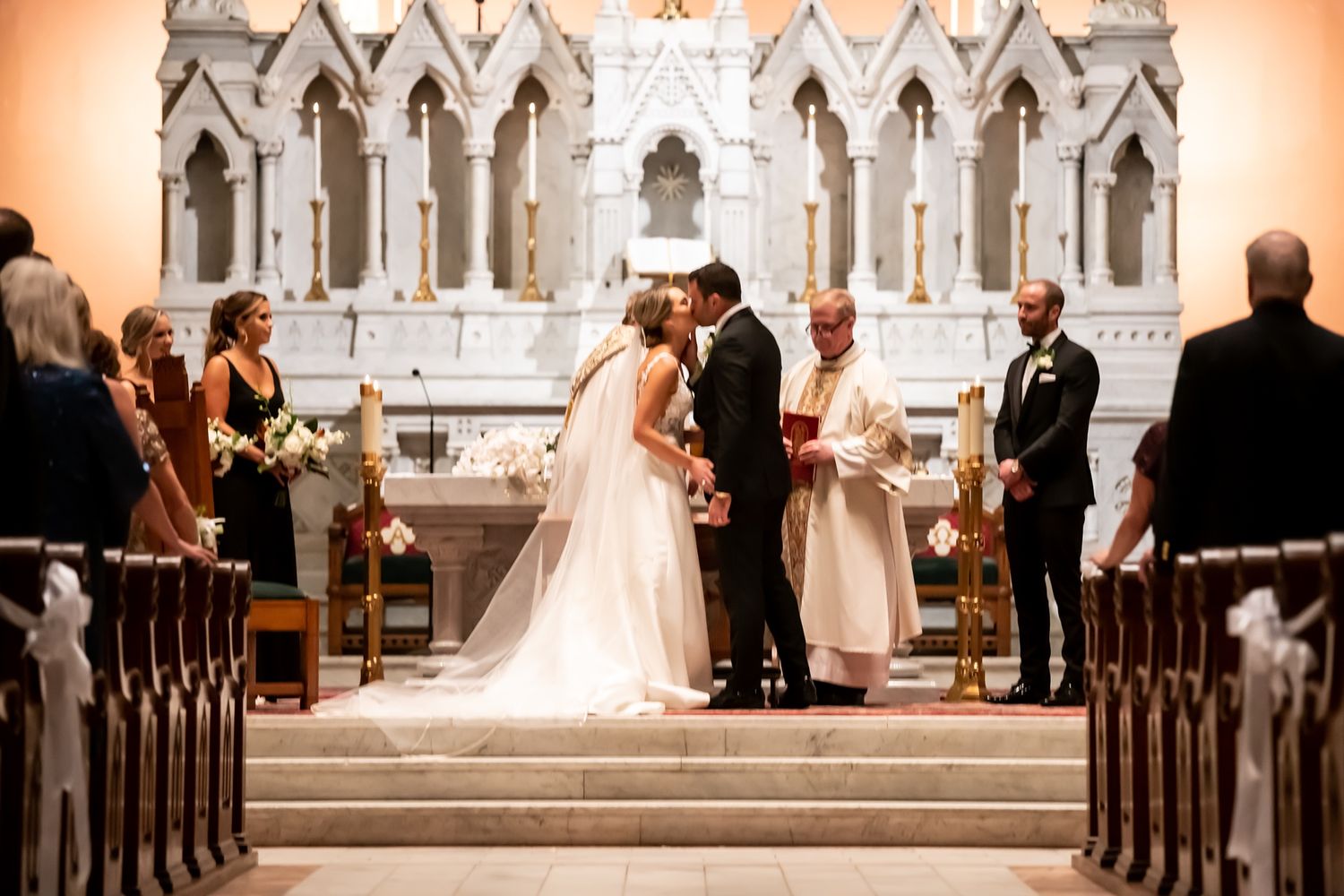 A panoramic view of a traditional church wedding ceremony showing the altar and pews from multiple angles.