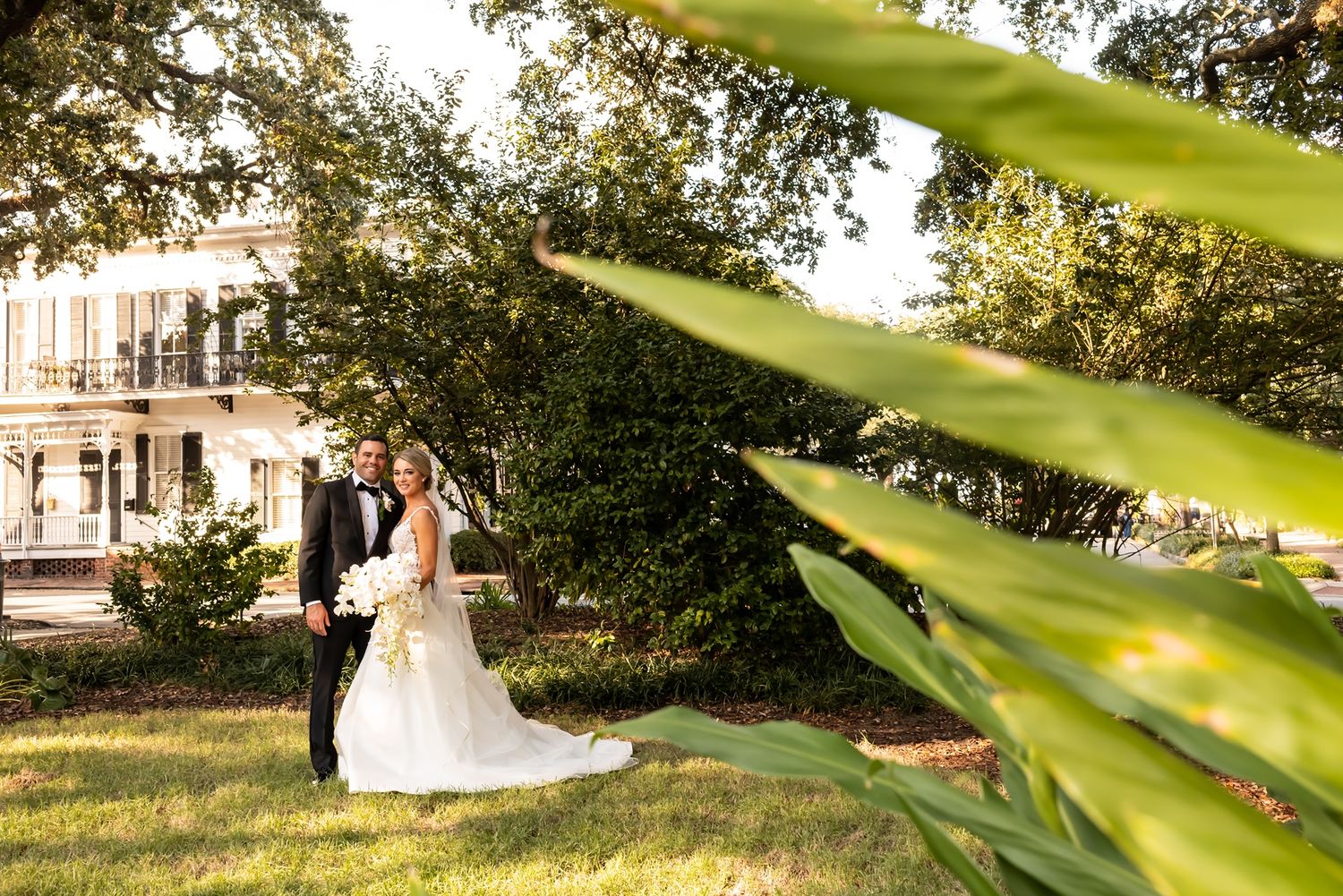 Elegant bride and groom share romantic moments in golden sunlight through lush gardens and classic architecture.