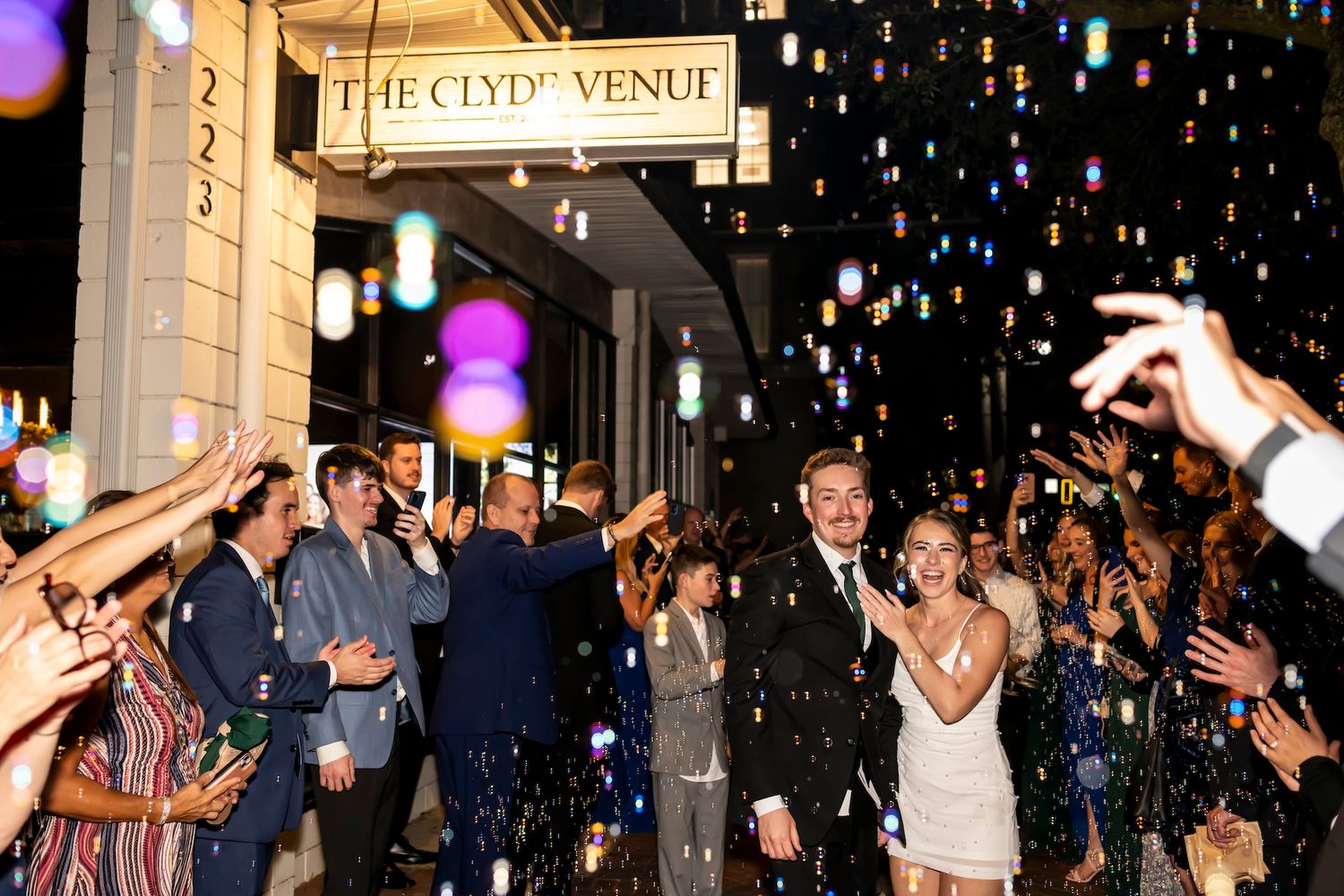 Wedding exit at The Clyde with couple walking through sparklers and confetti during their nighttime celebration.