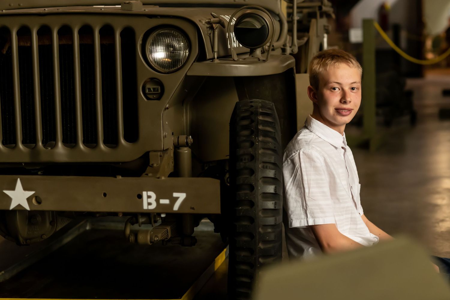 A vintage military Jeep with B-7 markings and white star emblem is shown in dramatic lighting.