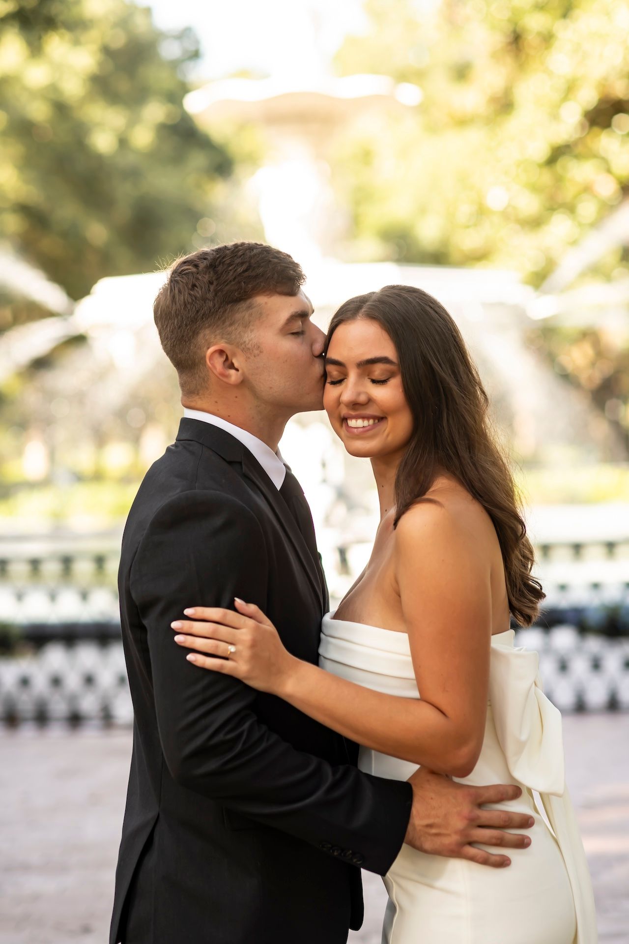 A happy couple shares intimate moments in a series of wedding photos outdoors with a white fence background.