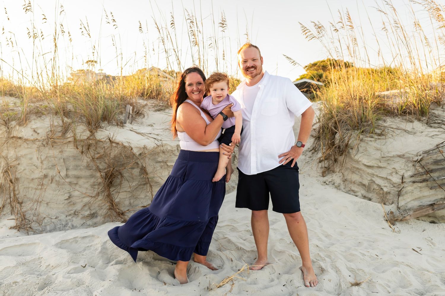 A series of five romantic beach engagement photos showing a couple posing together among sand dunes at sunset.