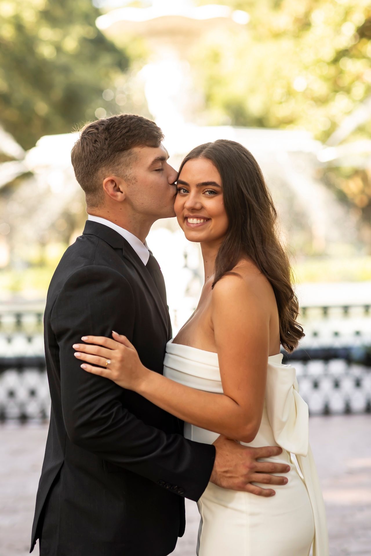A romantic wedding photo sequence shows a couple sharing joyful embraces and tender moments in formal attire outdoors.