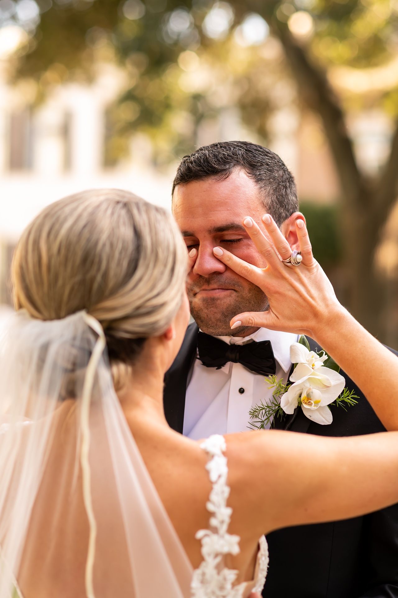 Close-up portrait of a bride and groom sharing tender moments during their outdoor wedding photoshoot at golden hour.