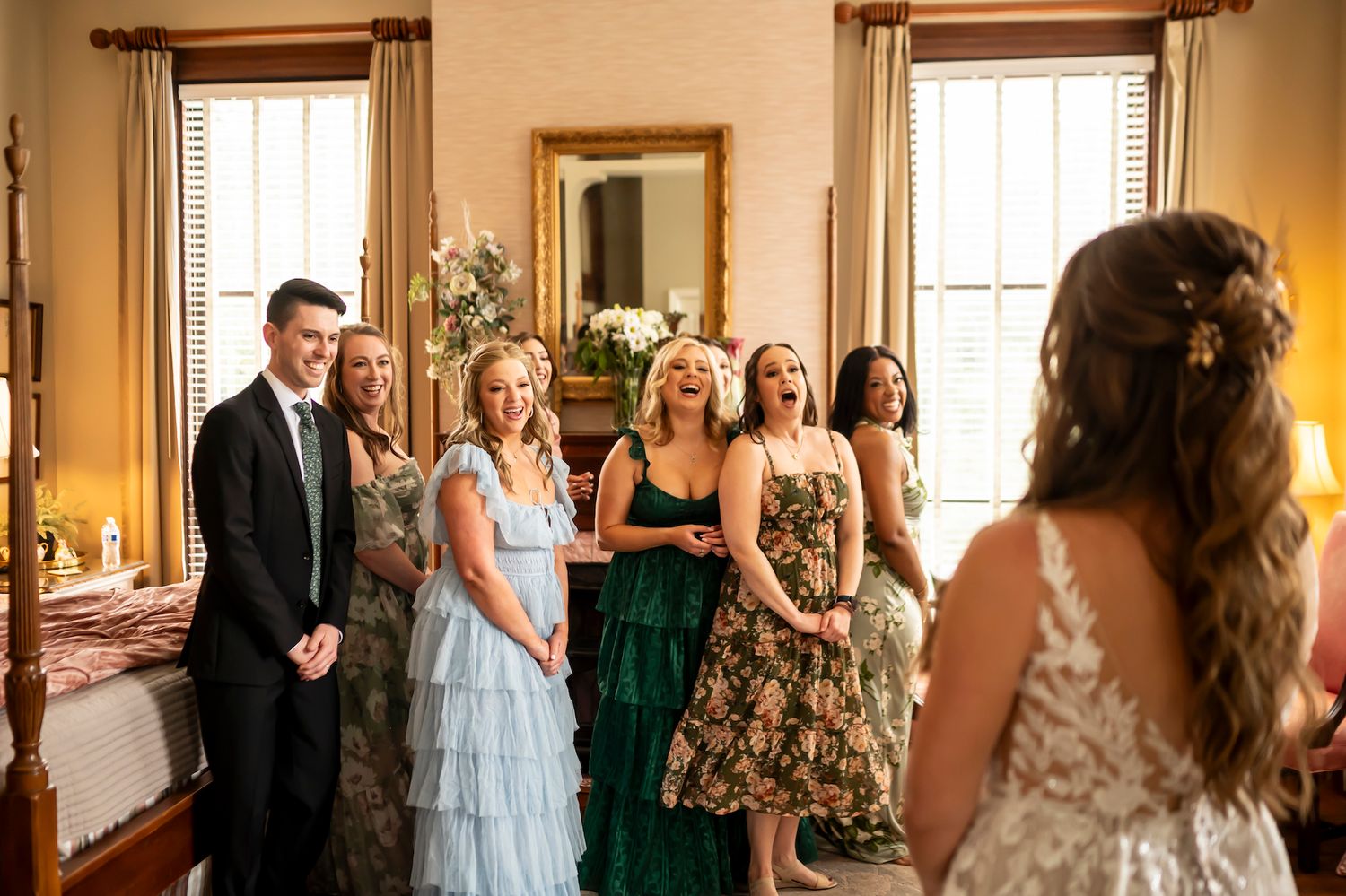 Wedding party members watch with emotion as they see someone in an elegant dress during a pre-ceremony gathering.