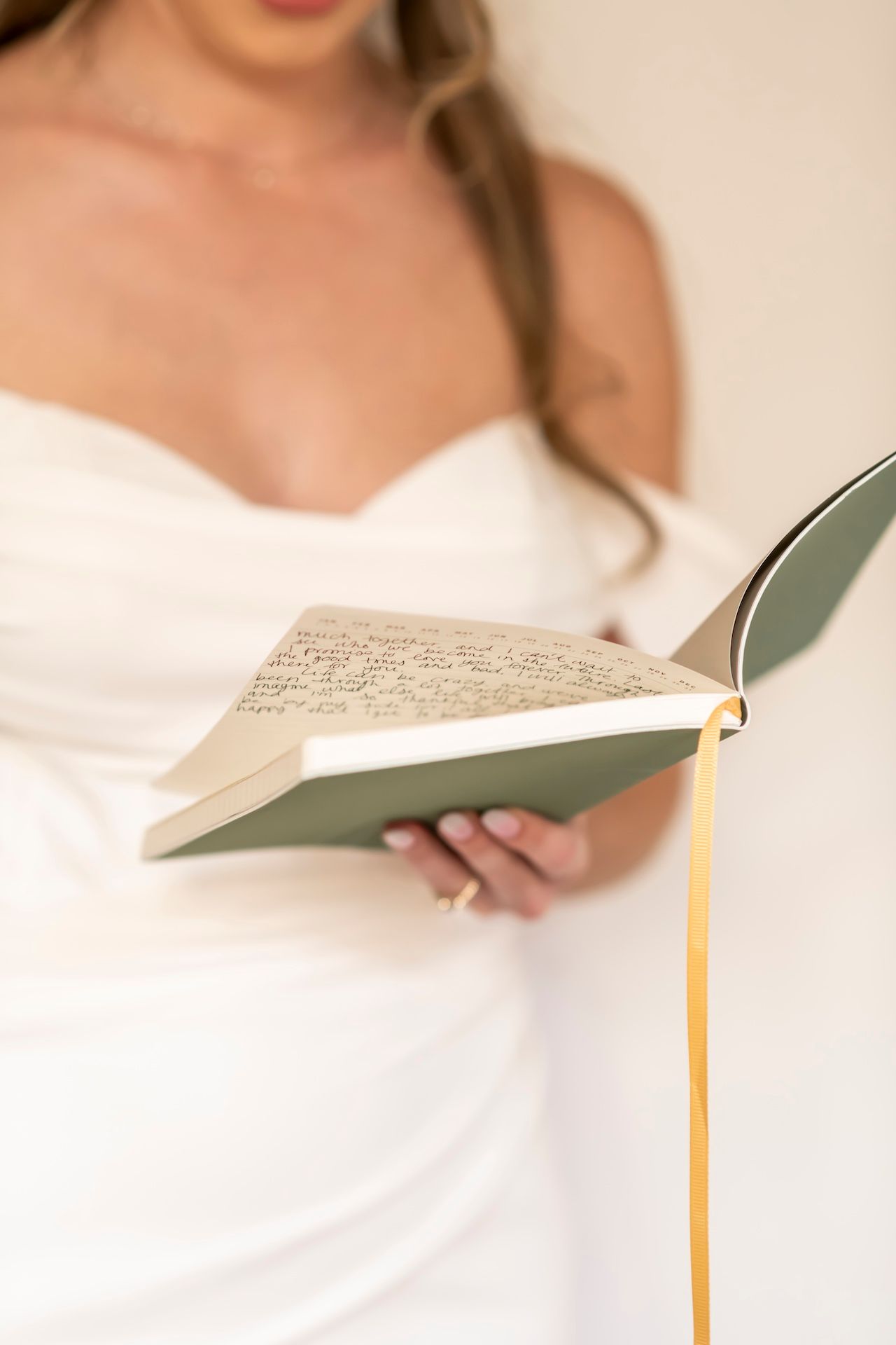 Close-up shots of person in wedding dress reading from a handwritten letter or note.