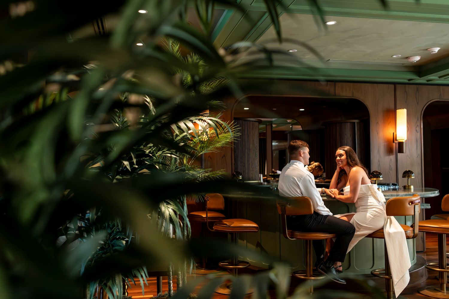 Moody restaurant scene with warm lighting and modern interior decor featuring intimate seating arrangements.