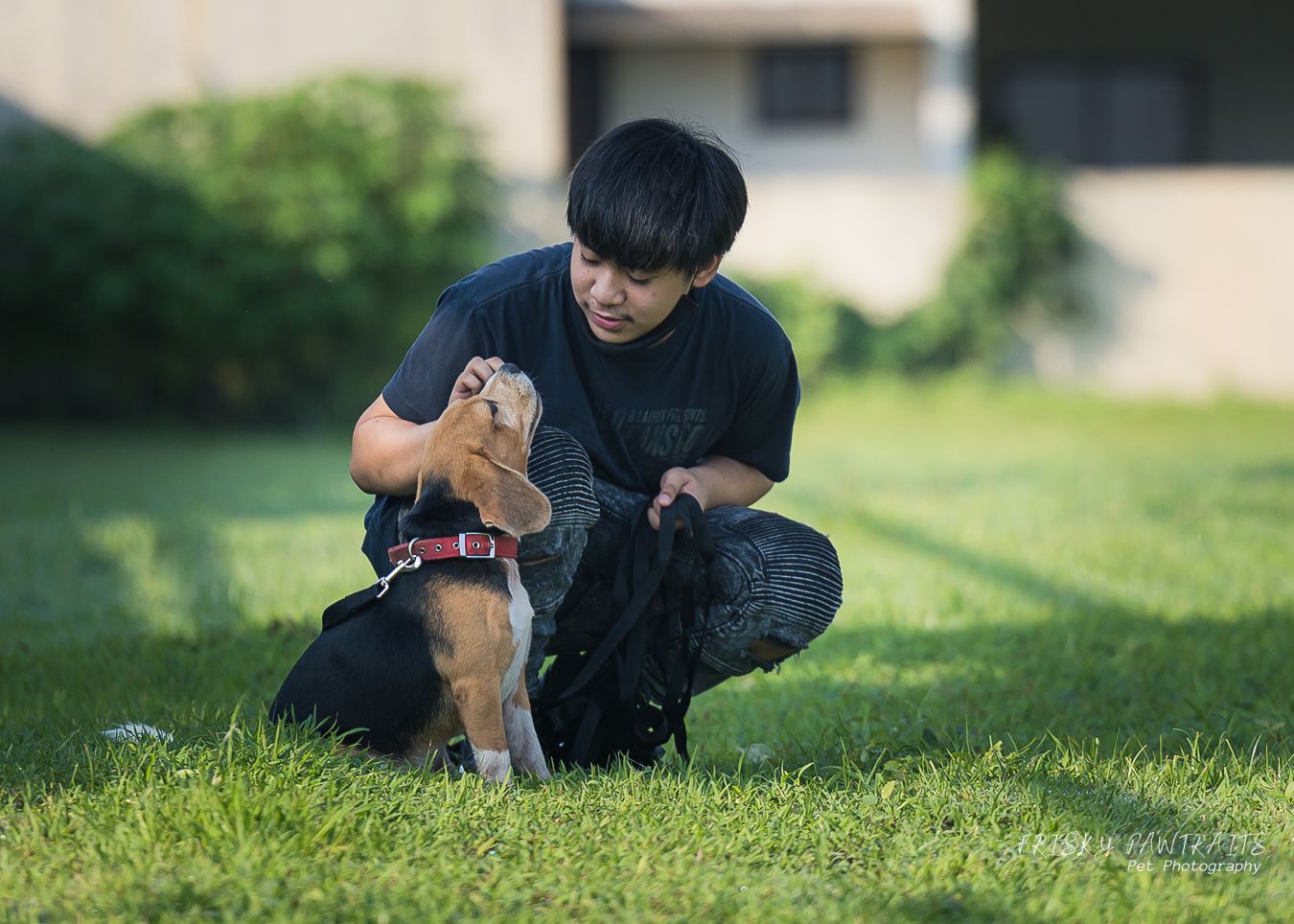a boy and her beagle enjoying their time at the park